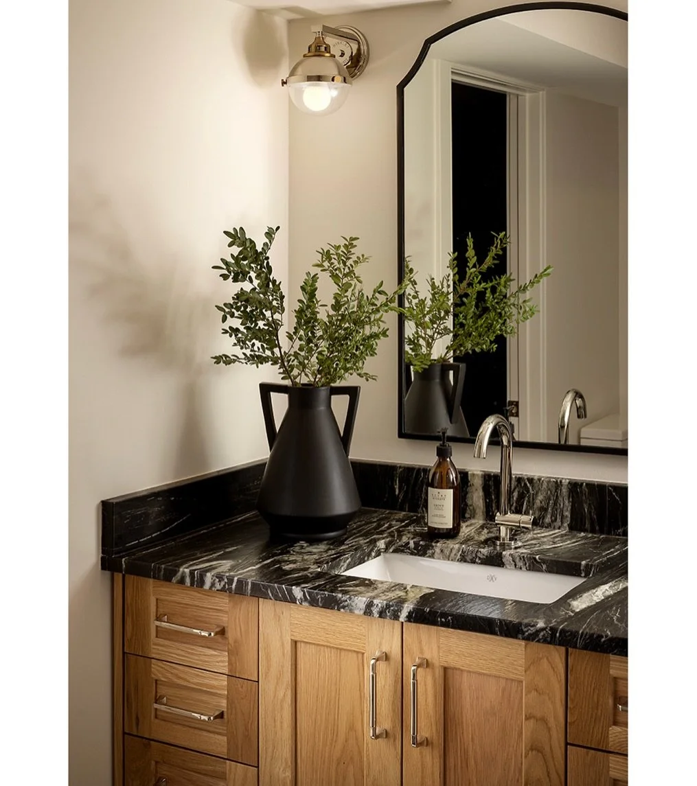 This little guest bathroom was designed to accommodate a powder room functionality being placed just outside the family tv room and kids gym space in a walk out basement. It also needed to function for aging parents coming to stay for longer periods 