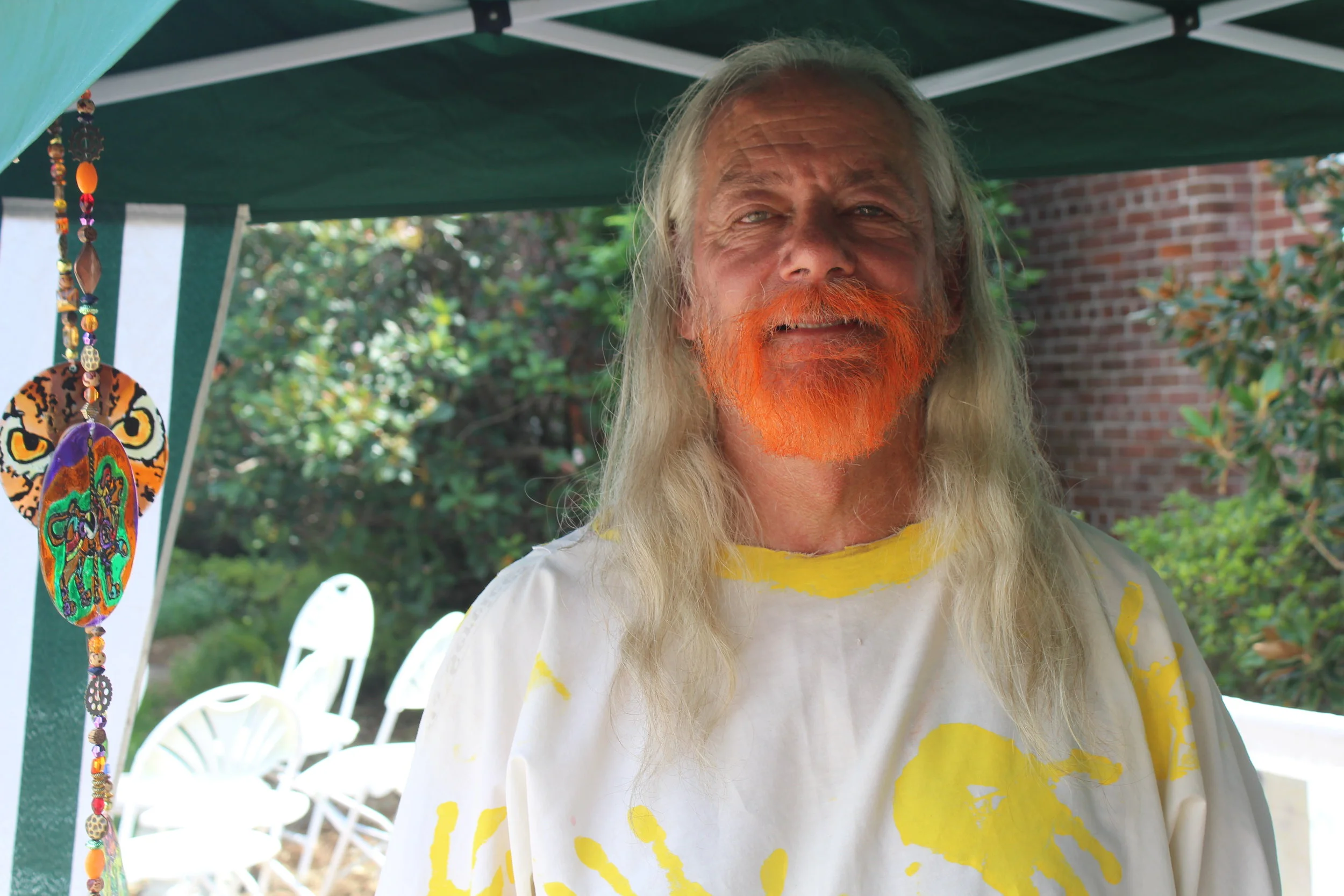 Randy Withers in front of his booth at Jacksonville Pagan Pride Day. He said that he makes items with symbols from different religions so that everyone can have something they love.