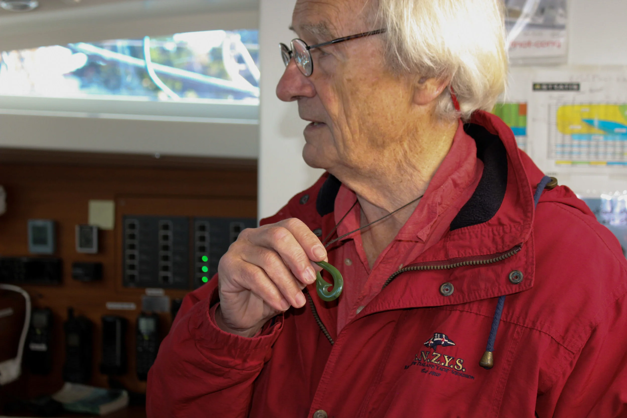 Paris holds the necklace he wears that matches the stone carving on his wall on the 53-foot Kiwi Spirit II.