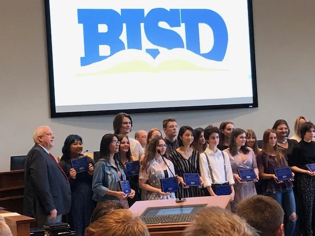 BISD Trustee Kelvin Dilks declined to perform on May 23 as Amon Carter in the new play he stars in because of his responsibility to serve on the Birdville school board. Here', he is shown (at left) with students who were honored at the meeting.