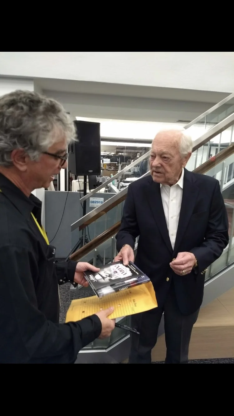 The author of this post, Dave Lieber presented Bob Schieffer with his new book on Amon Carter. (Photo by David Tarrant, Courtesy of DMN.)