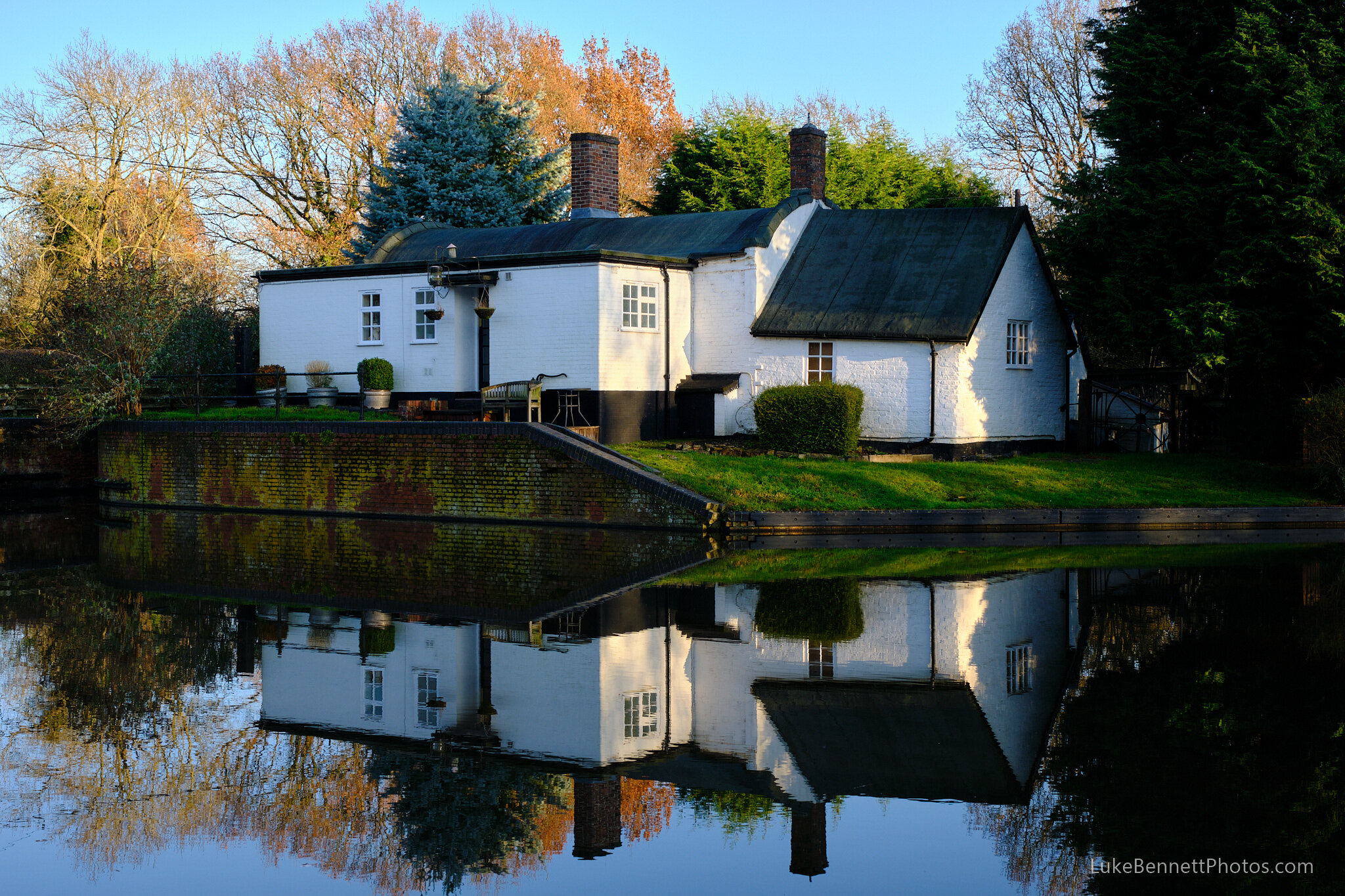  www.lukebennettphotos.com  A pretty house reflecting on a large turning section of the Grand Union waterway.  