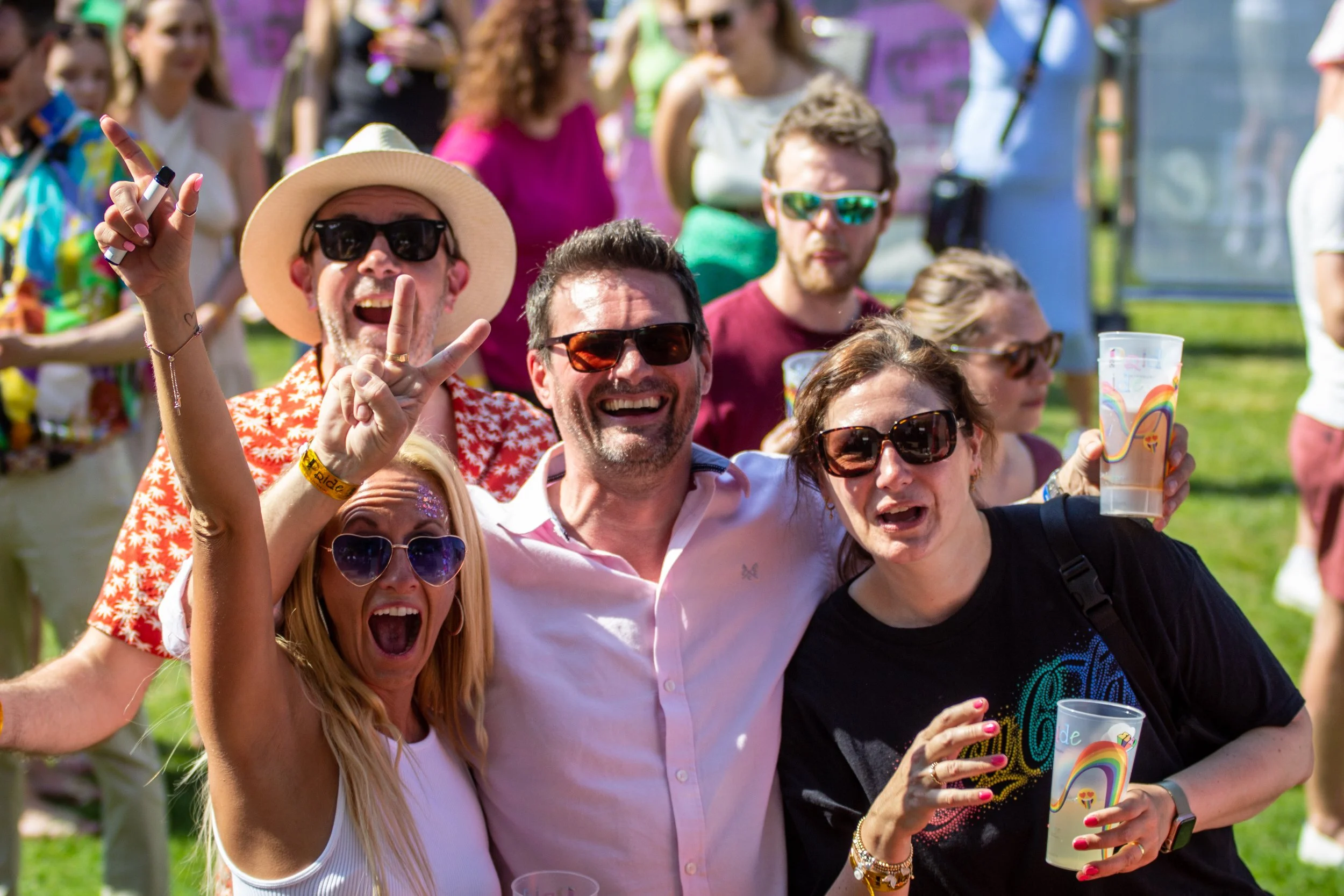 Photo of four people smiling at the camera at Pride Canterbury.