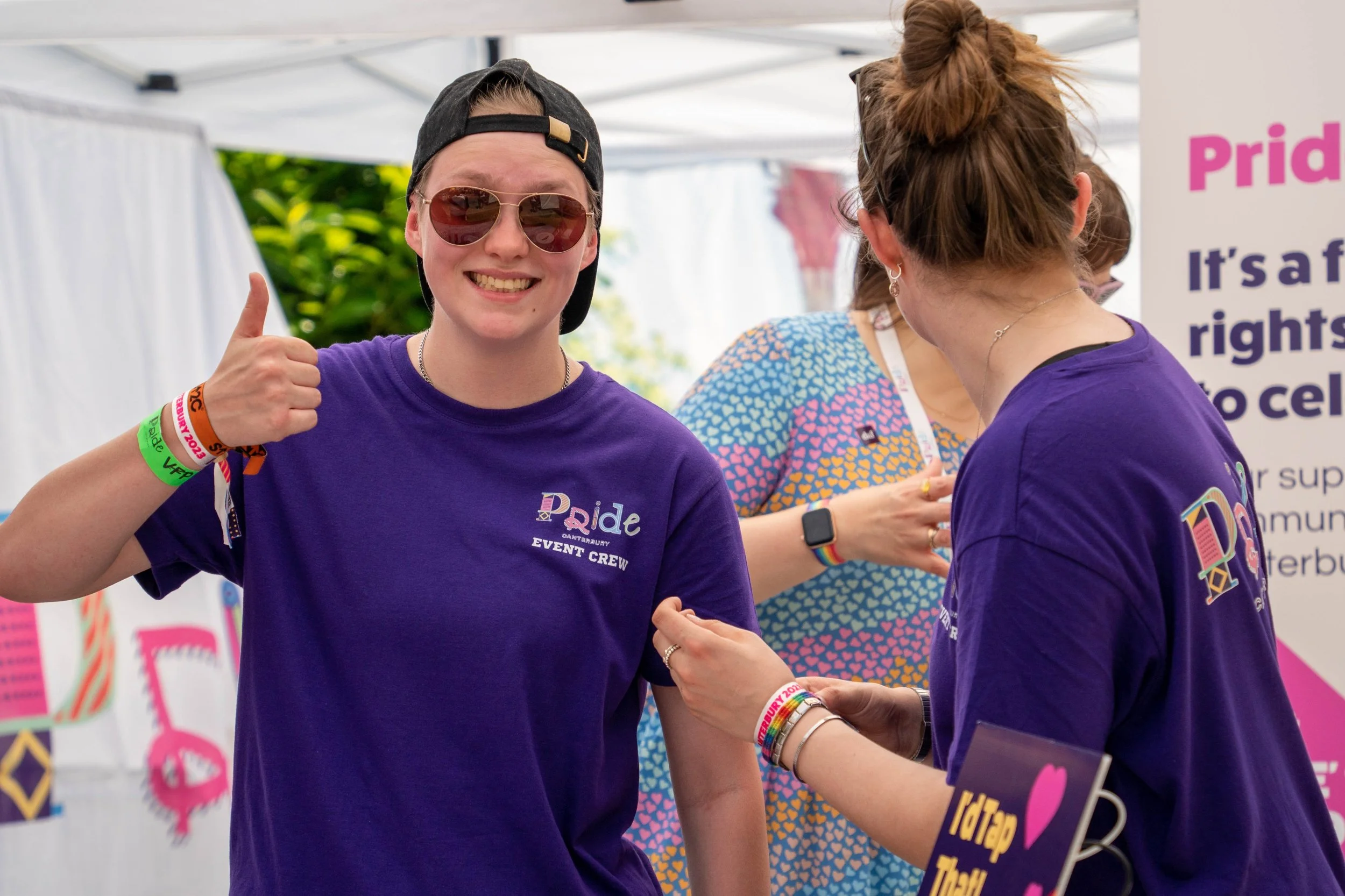 Photo of one of the pride crew looking excited at the Pride HQ Information Point.