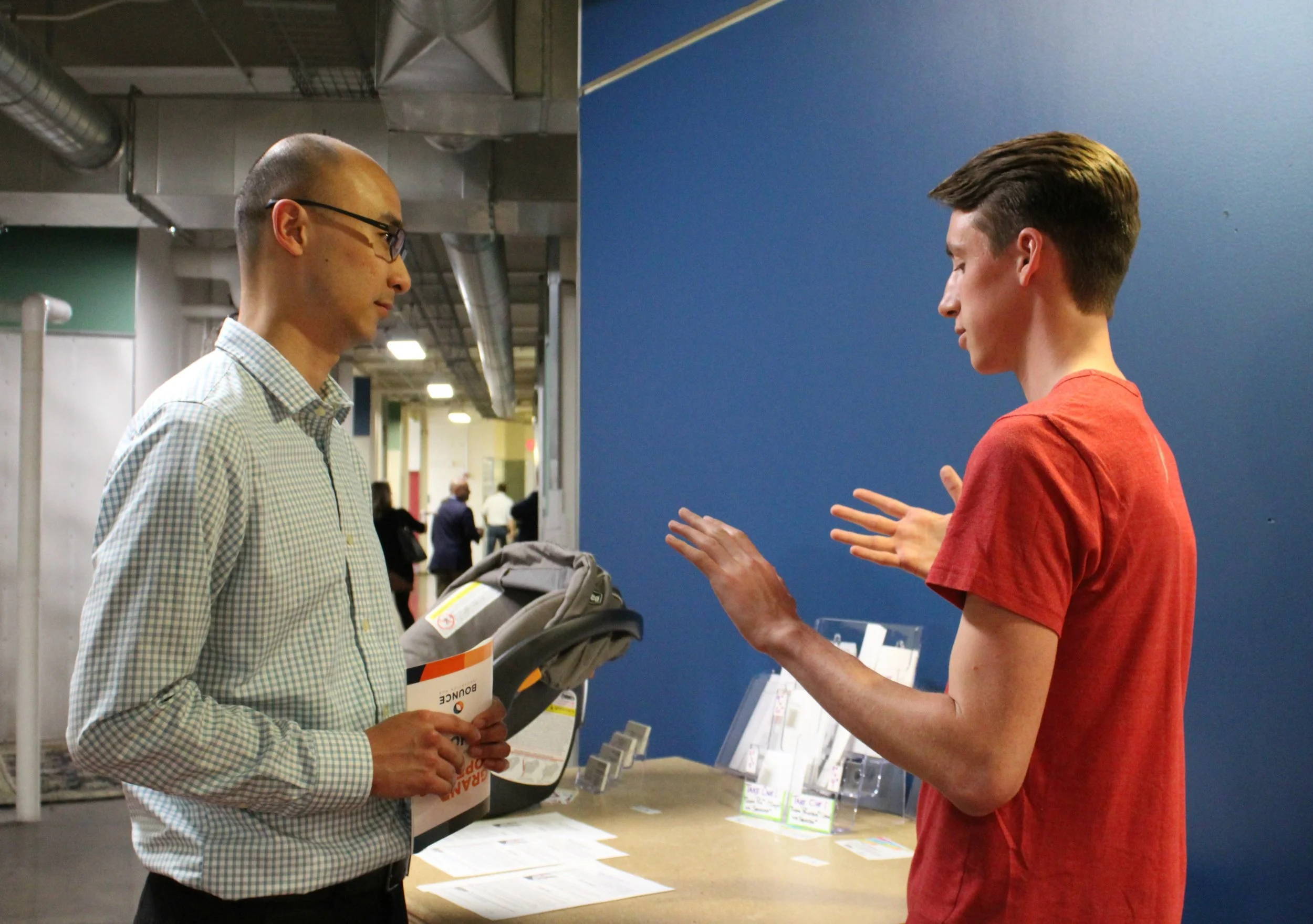 Joe explains the science behind our dry adhesive material to a visitor during the open house.