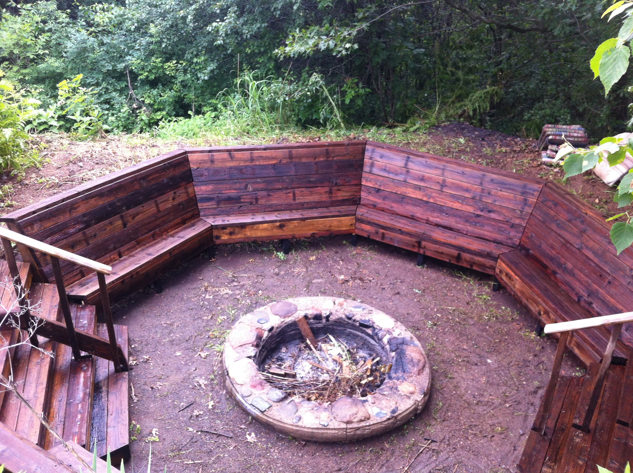  Salvaged redwood decking gives the fire pit a warm feel. A perfect  spot for an intimate  gathering. 