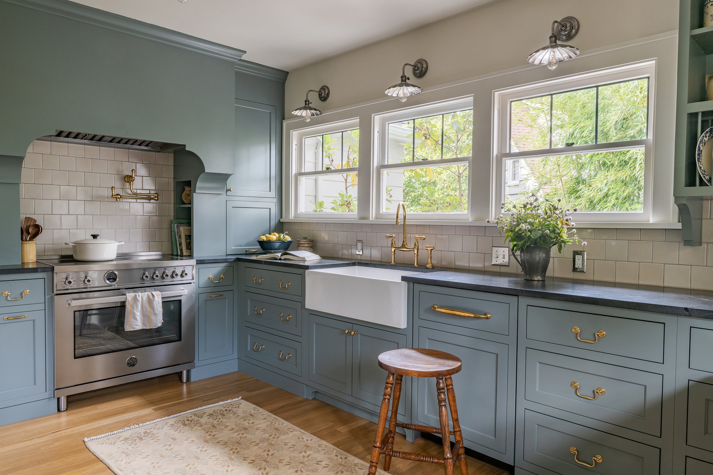 Studio Laloc Kitchen with large statement hood, fireclay tiles and apron front sink