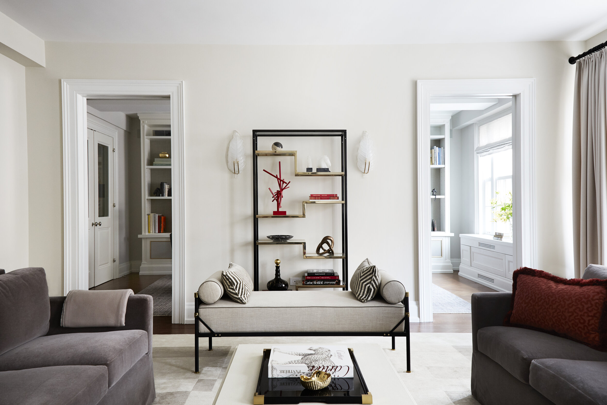 cream living room with brass etagere and bench