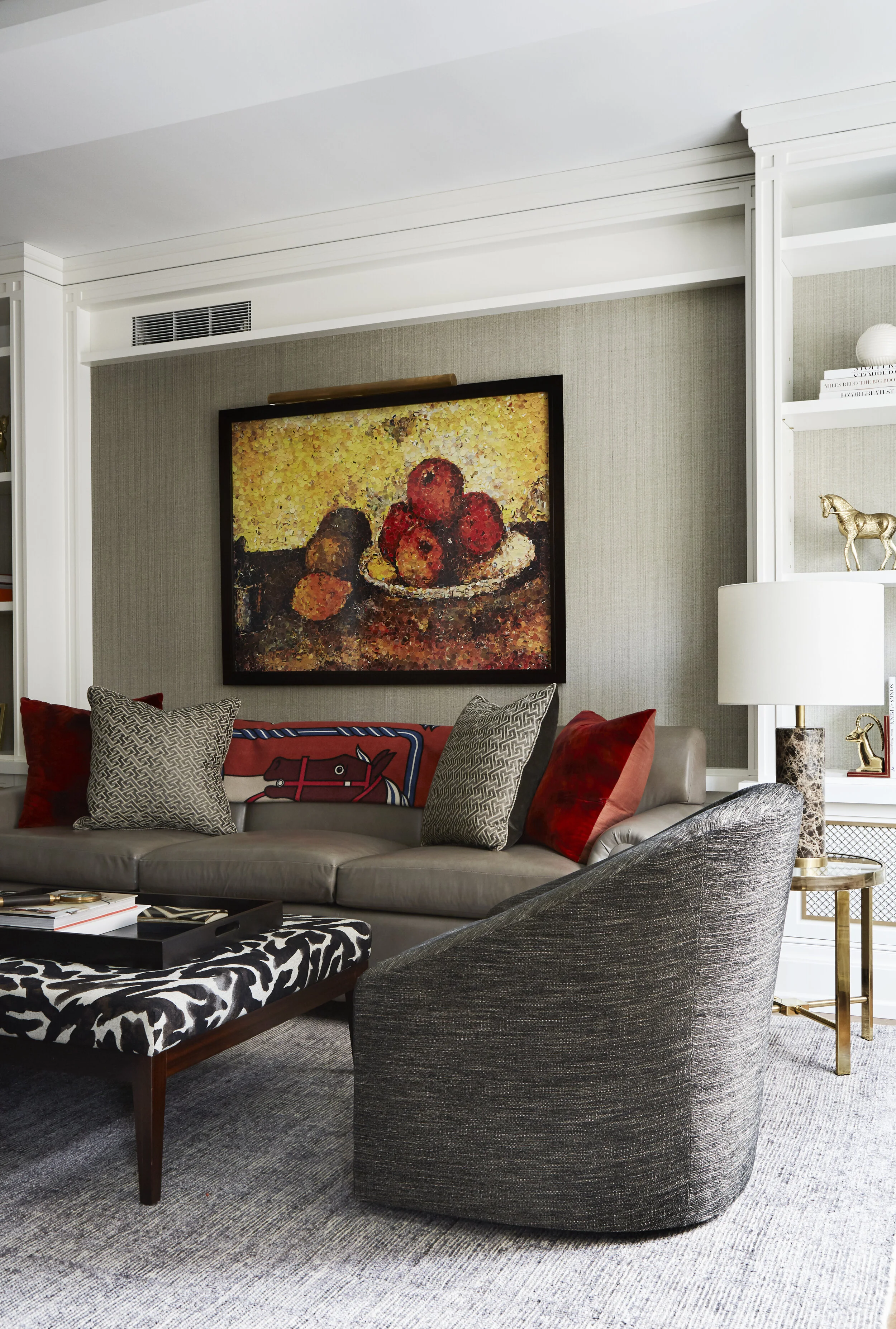 gray leather sofa with heather gray barrel back chair, zebra ottoman, and hermes throw blanket