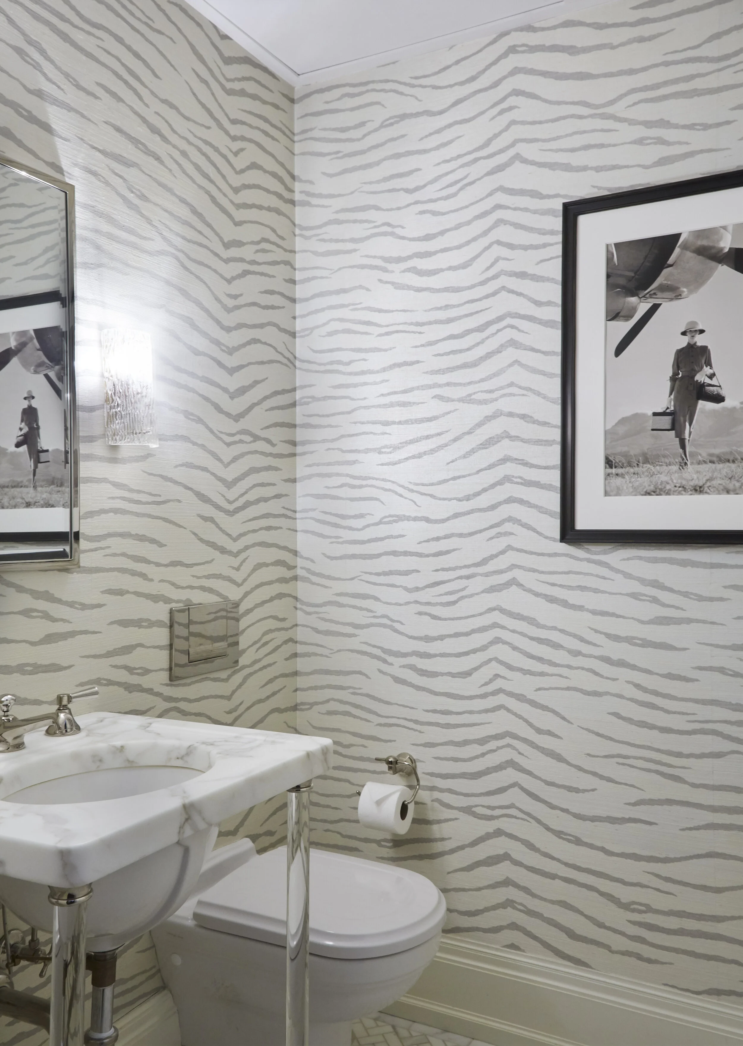 Zebra powder room with nickel accents and lucite vanity
