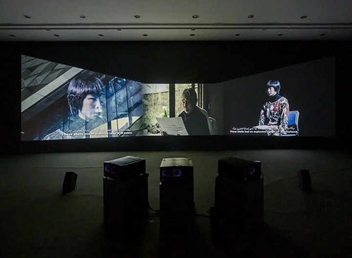 Meiro Koizumi, The Angels of Testimony (2019). Three-channel video installation, colour, sound, archival material. Duration and dimensions variable. Commissioned by Sharjah Art Foundation. Exhibition view: Sharjah Biennial 14: Leaving the Echo Chamber (7 March–10 June 2019). Courtesy Sharjah Art Foundation.