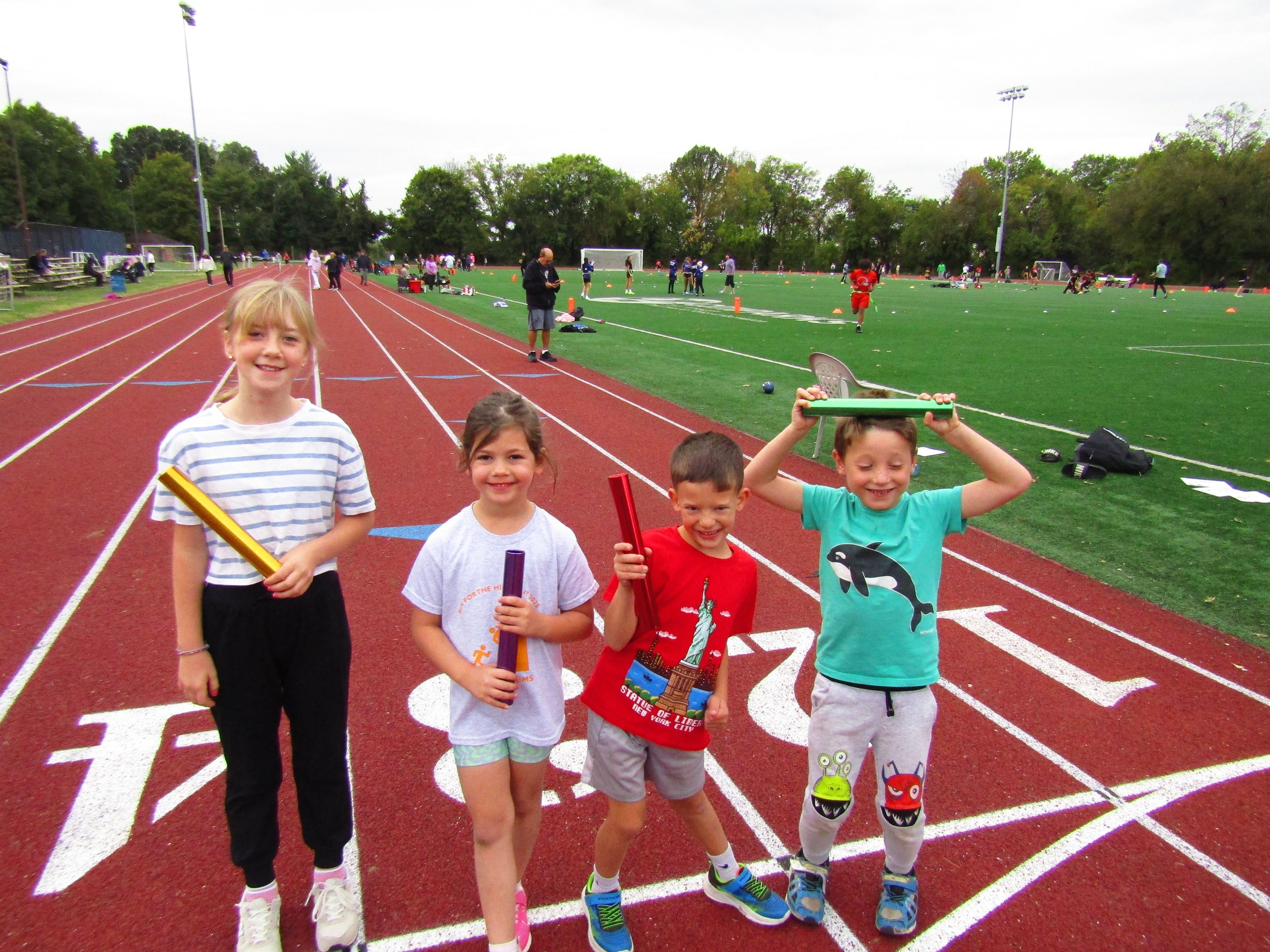 Run Your City_children-holding-batons-on-track.jpeg