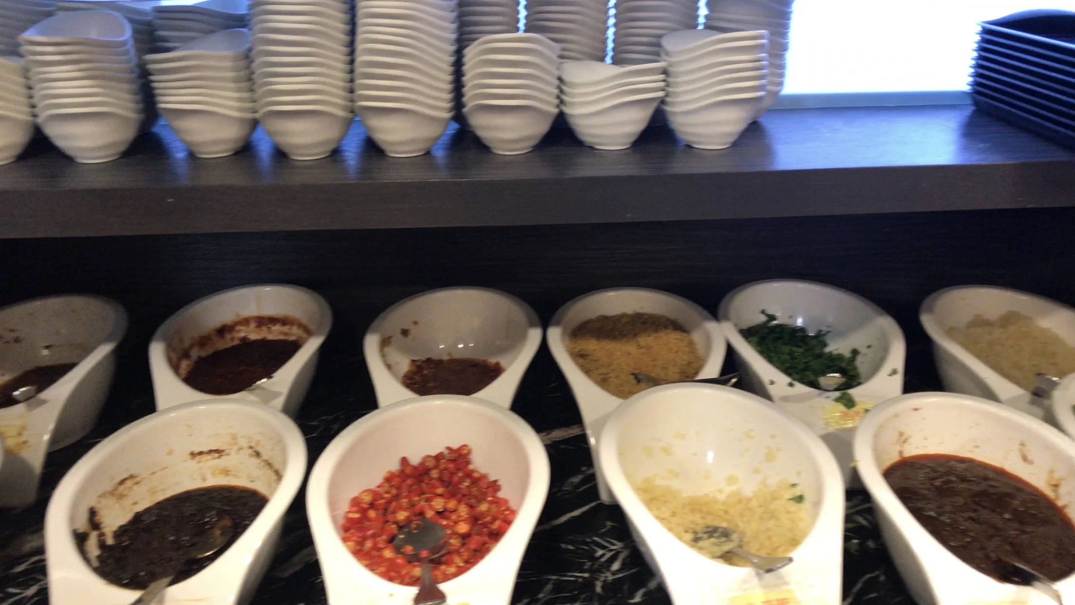 While you wait for your seafood to cook, you make your own personal sauce. It’s up to you to choose which sauces you like and want to mix together. There’s options for soy sauce, sesame sauce or peanut butter as a base. Then add ins are pictured below: garlic, green onion, parsley, cilantro, peppers, chilies and more!