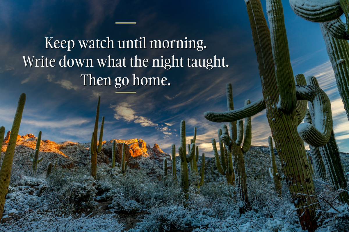 Saguaro cactus on a snow-dusted desert slope at first light, red rock ridge lit gold behind them, with the line in white serif: Keep watch until morning. Write down what the night taught. Then go home.