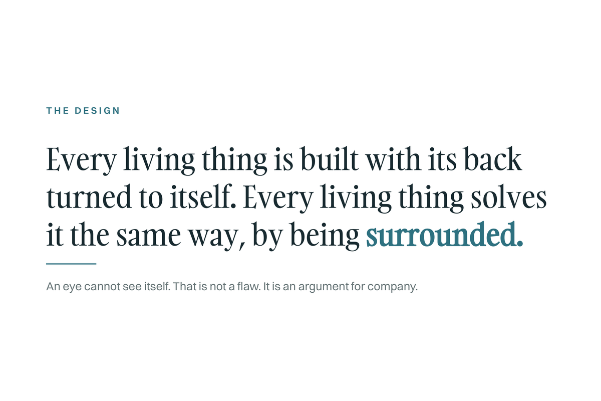 The Design card: every living thing is built with its back turned to itself and solves it by being surrounded. An eye cannot see itself, which is an argument for company.