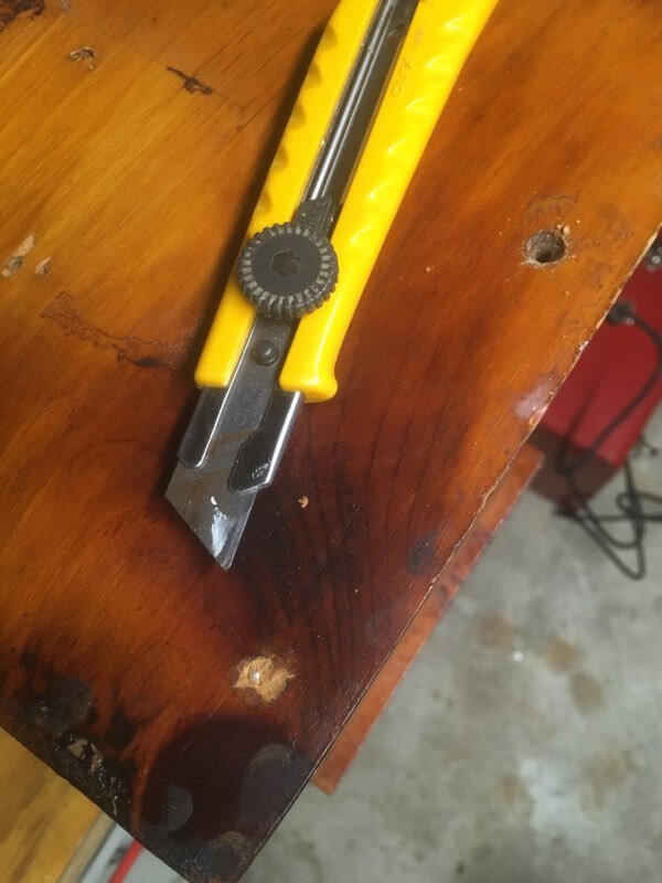 Removing filler covering screw heads.
