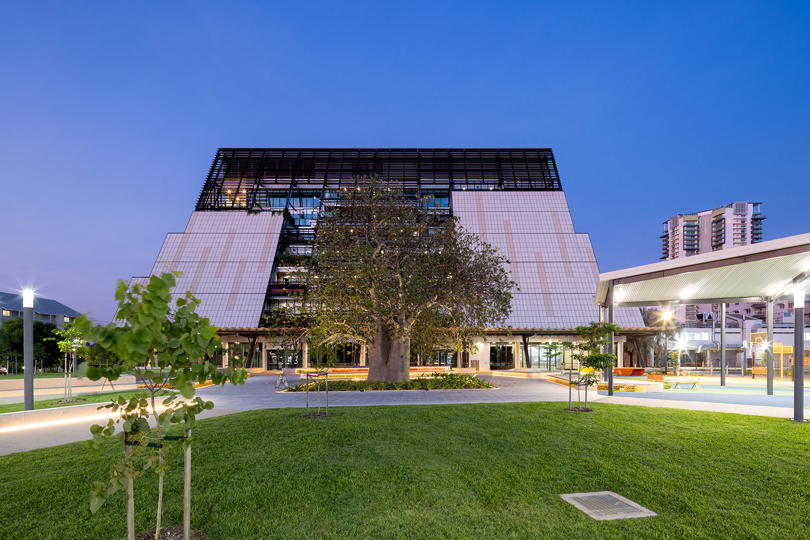 CDU Danala, Charles Darwin University is a Modern multi-story building with a large heritage Boab tree in front. Building includes learning environment, library, art gallery, radio station.