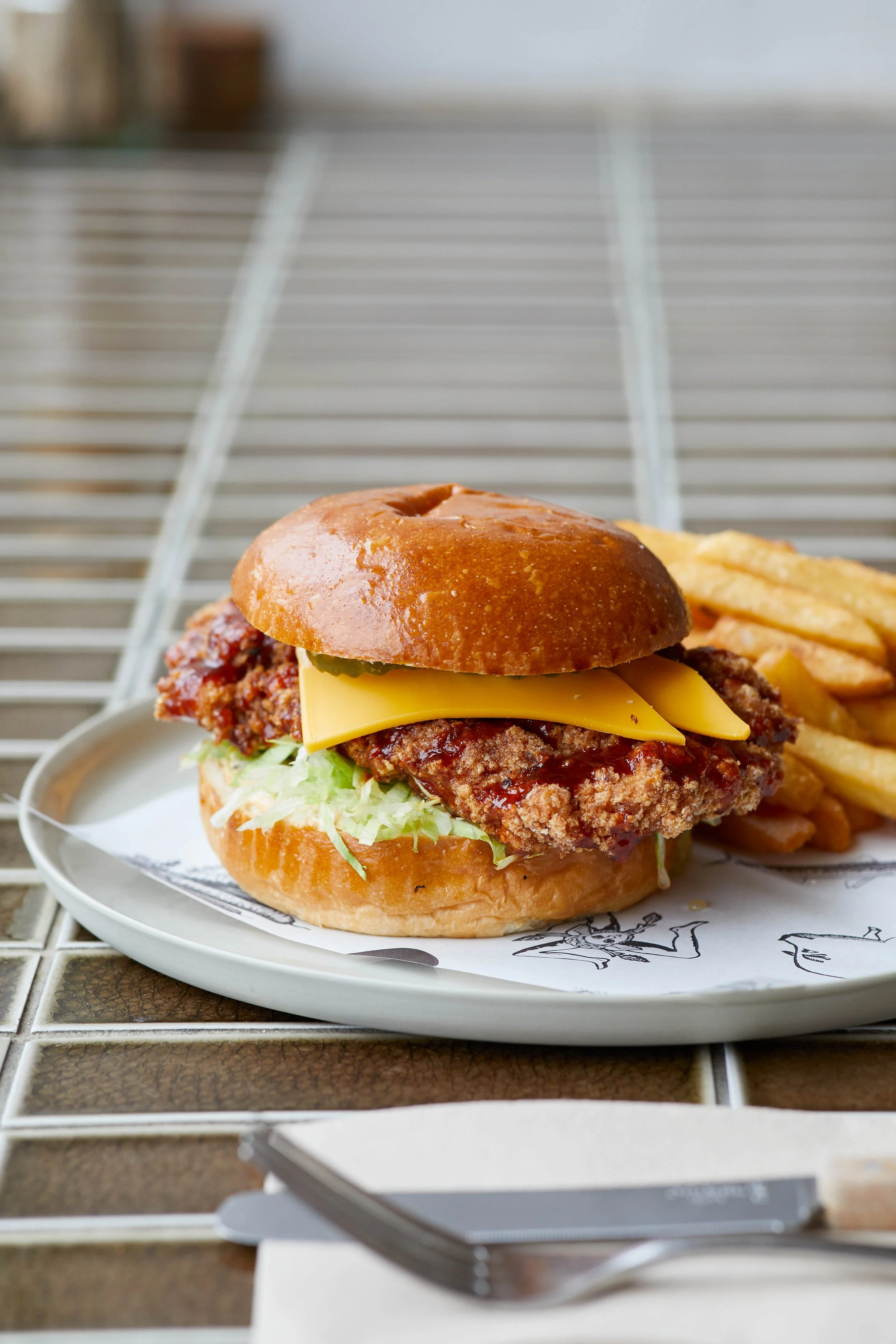  Fried Chicken Bun w. Swicy Sauce, Iceberg Lettuce, Jack Cheese, Pickles, VP Burger Sauce &amp; Chips. 