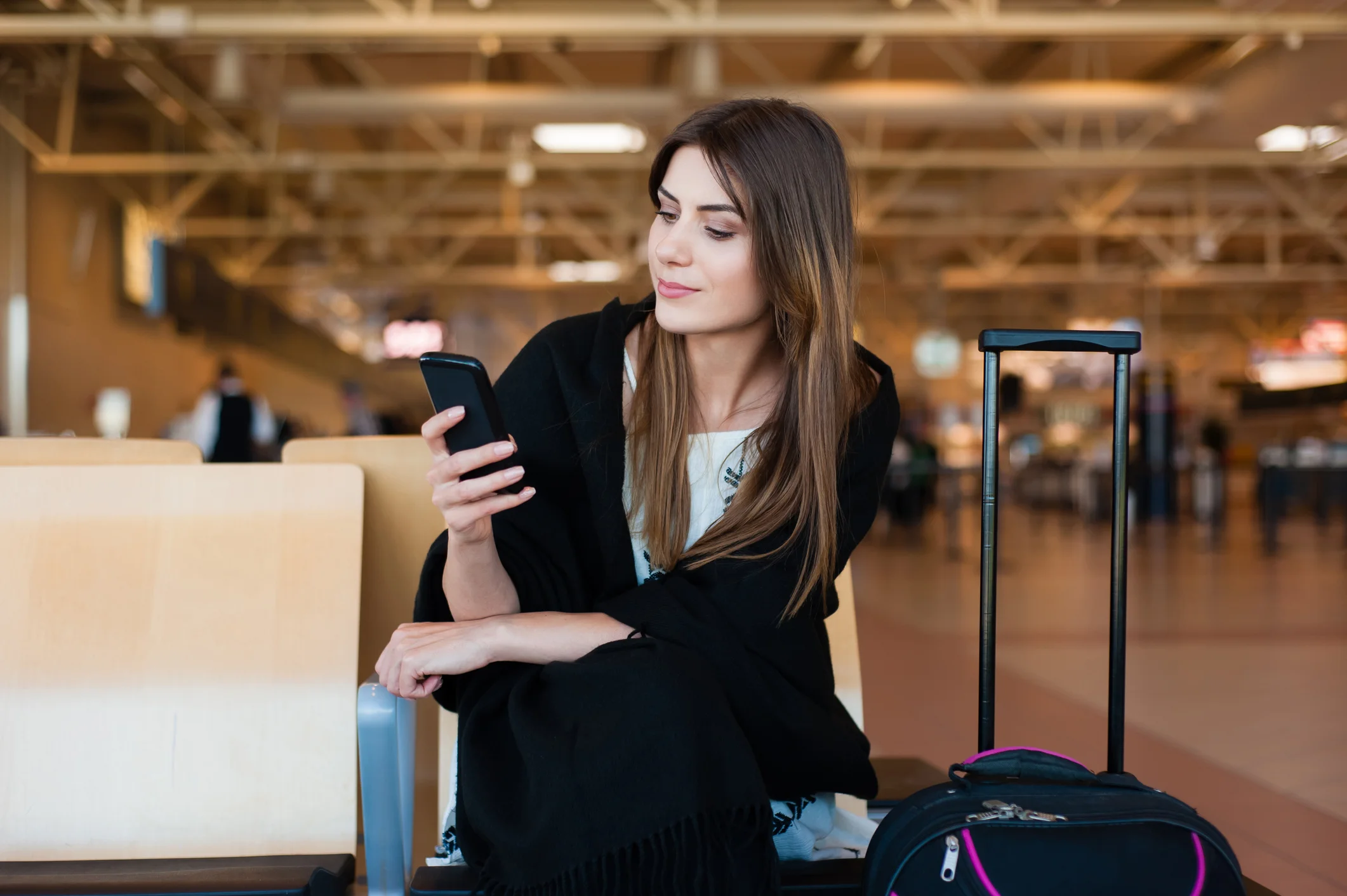woman wearing black cashmere travel sweater at airport