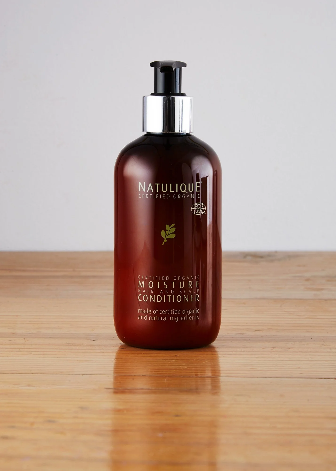 Professional tabletop product photograph of a bottle of hair product for ecomm, website sales