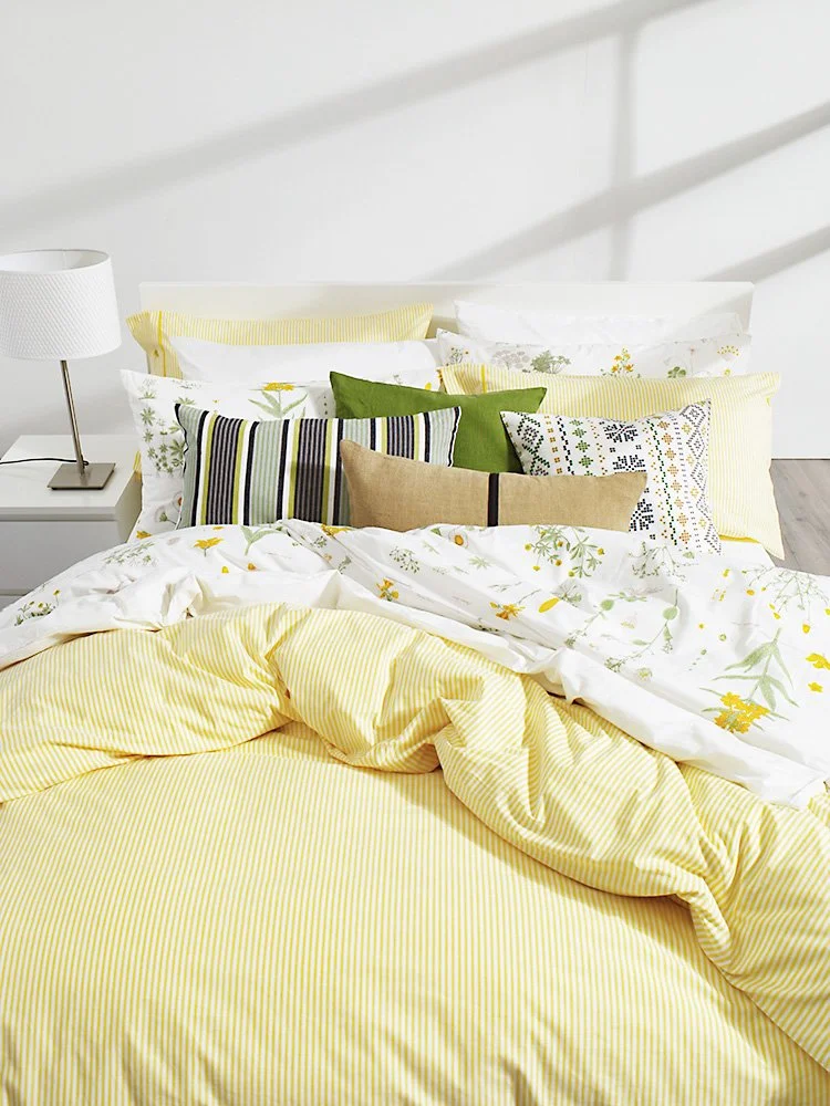 IKEA room set photo of a yellow bed in a bright bedroom