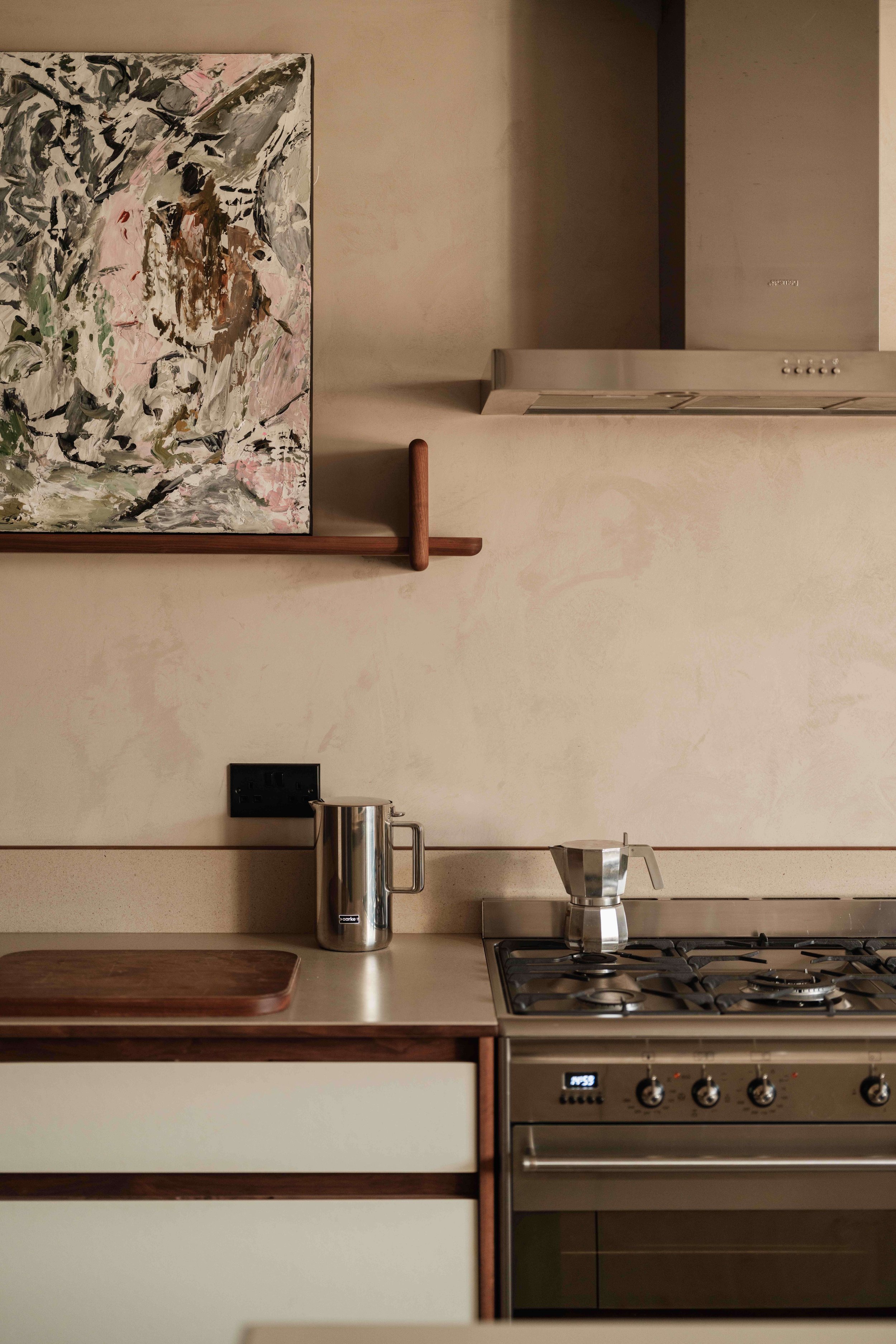 clean modern kitchen with artwork and stovetop