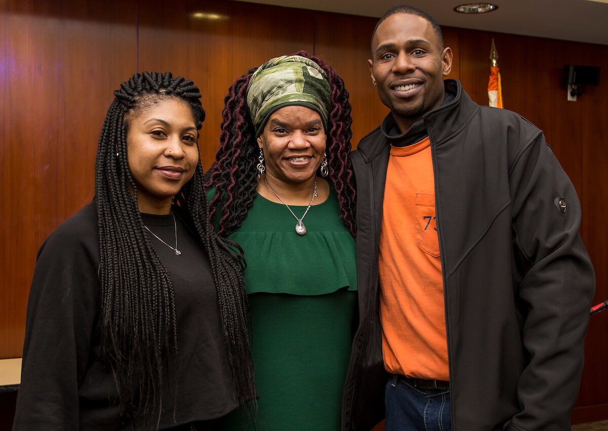 Yolanda with a family reunited by the program she runs at NYCHA