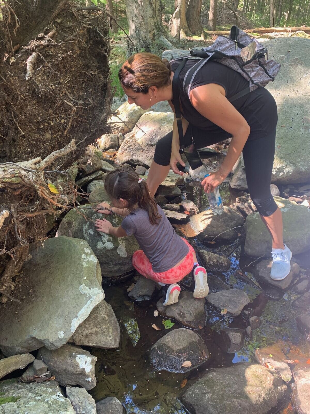 jesse helping child by rock .jpeg