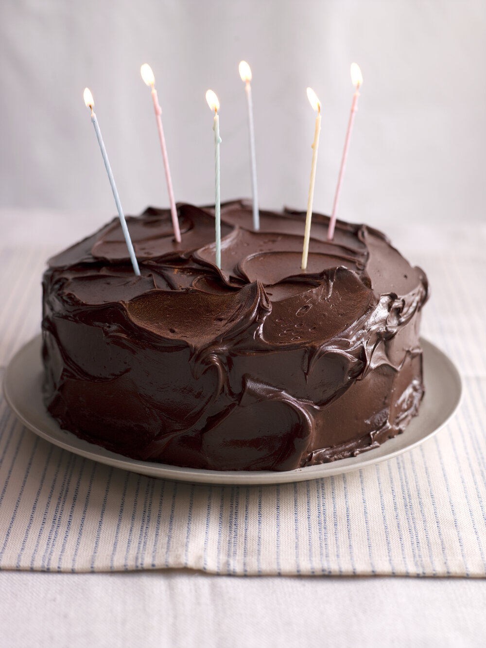 Cake with chocolate frosting and candles 