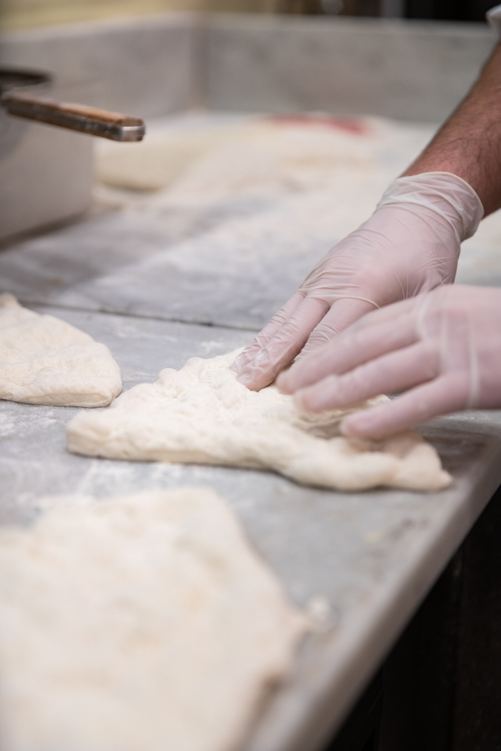 hands shaping dough into a calzone 
