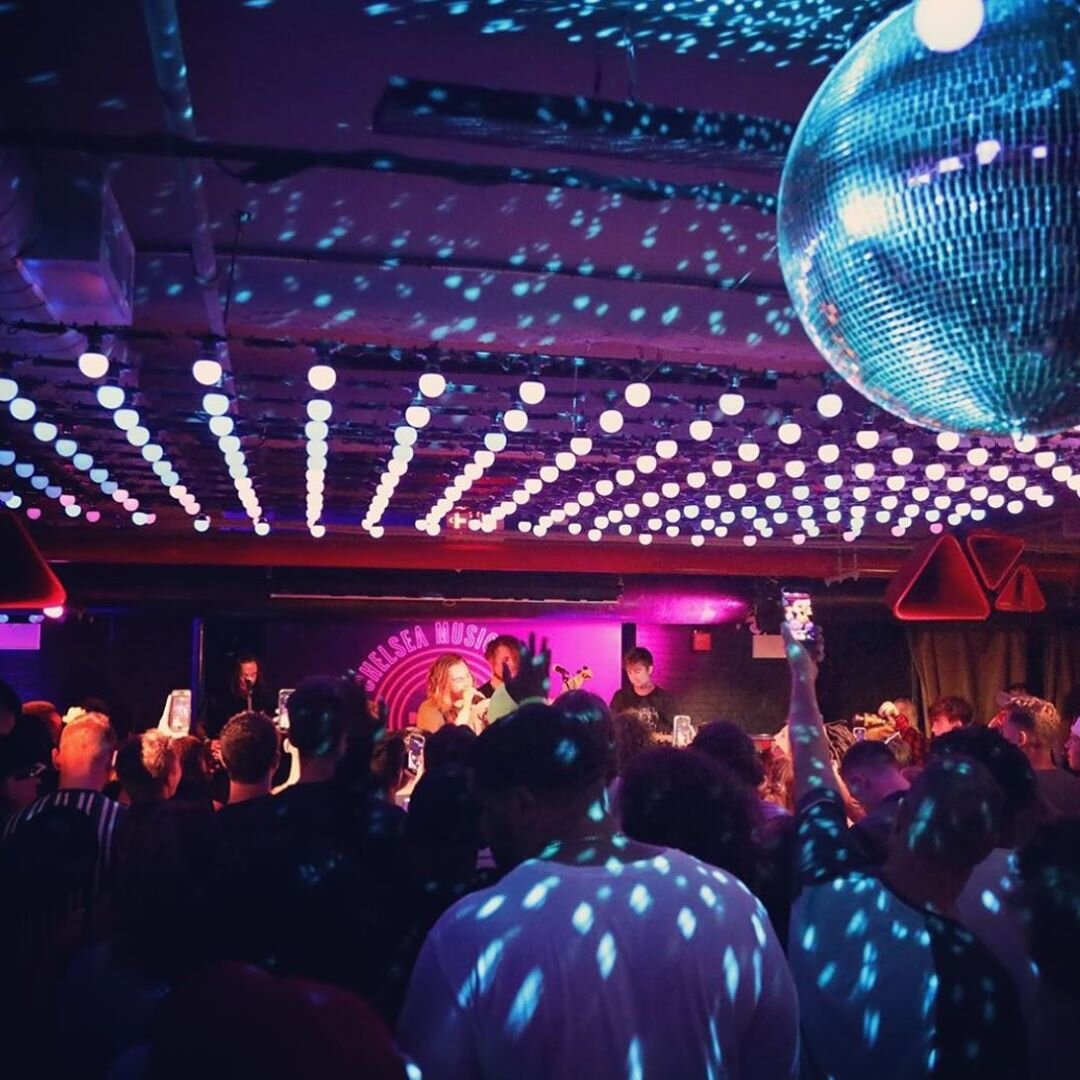 dimly lit room with disco ball and pink ceiling lights, People dancing