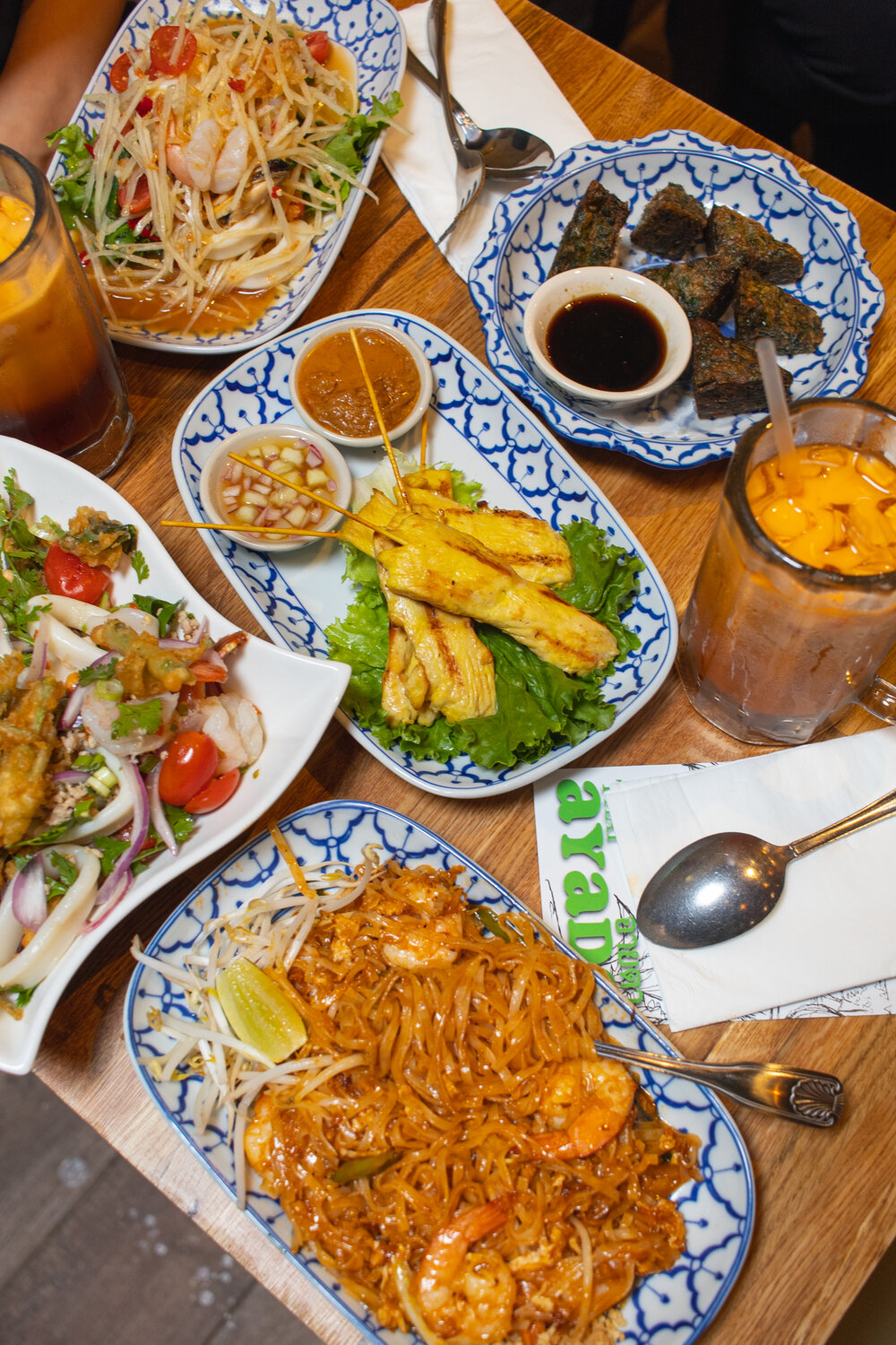 overhead shot with various thai food dishes on a table
