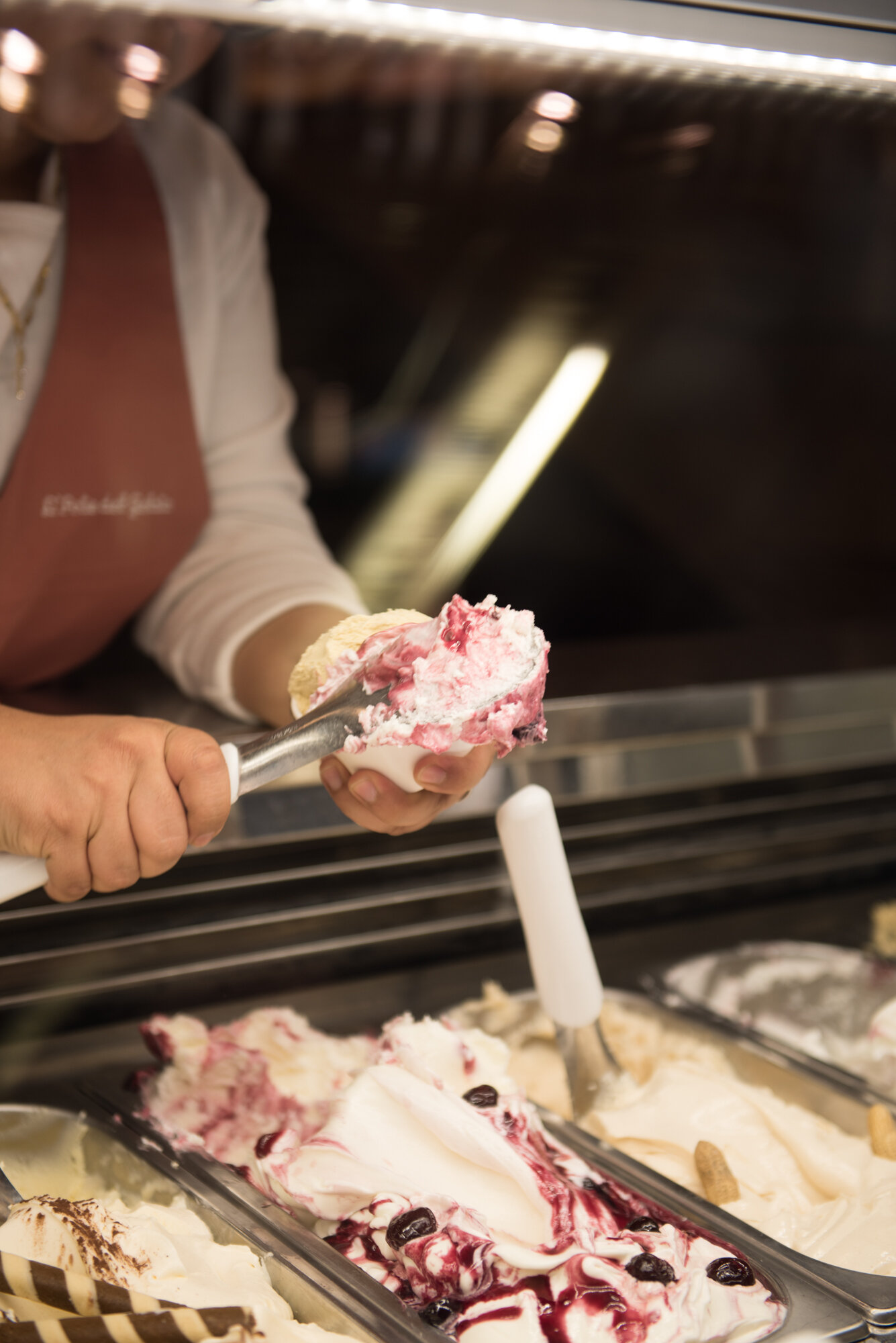 scooping gelato into a cone 