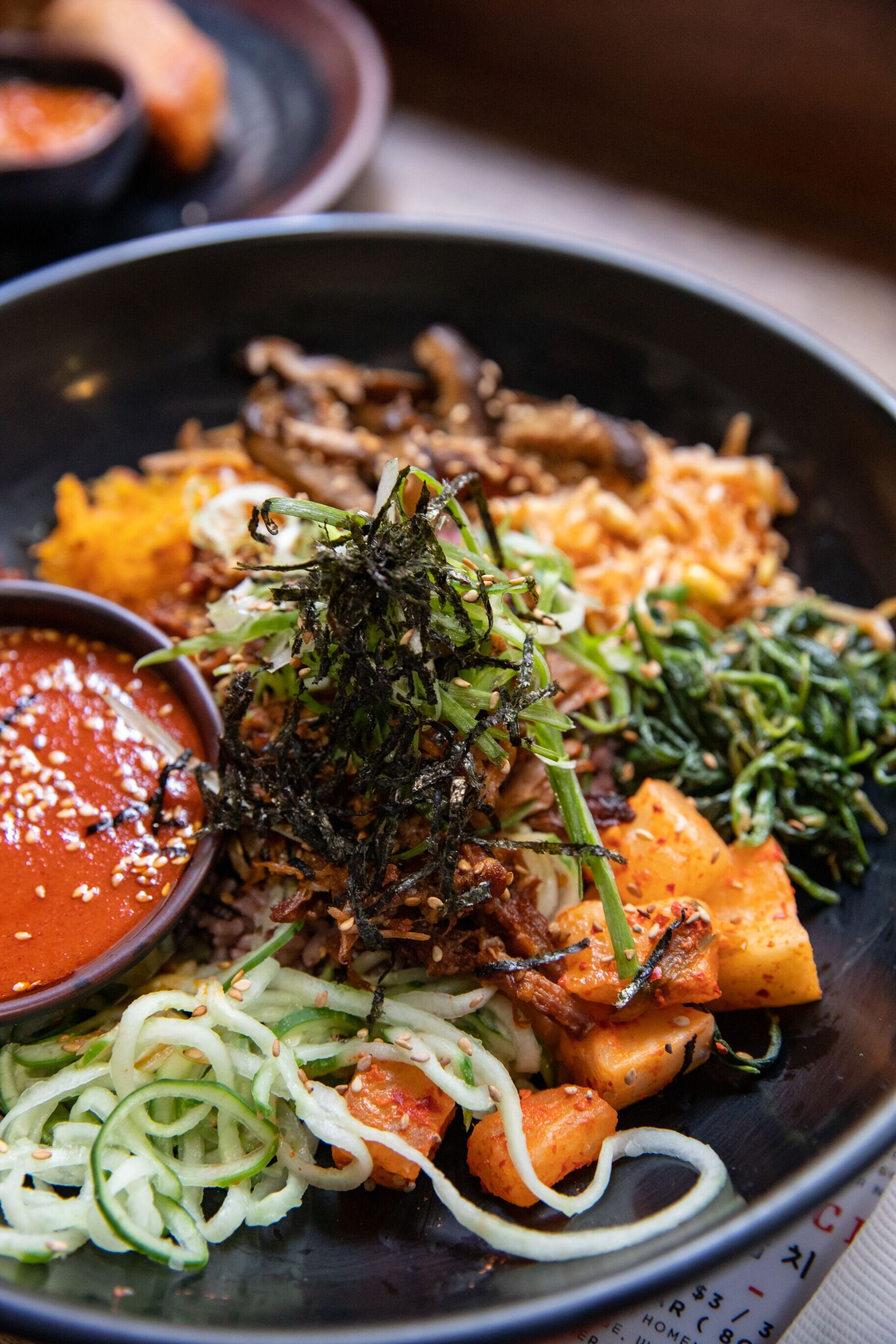 close up shot of bim bap bowl with meat