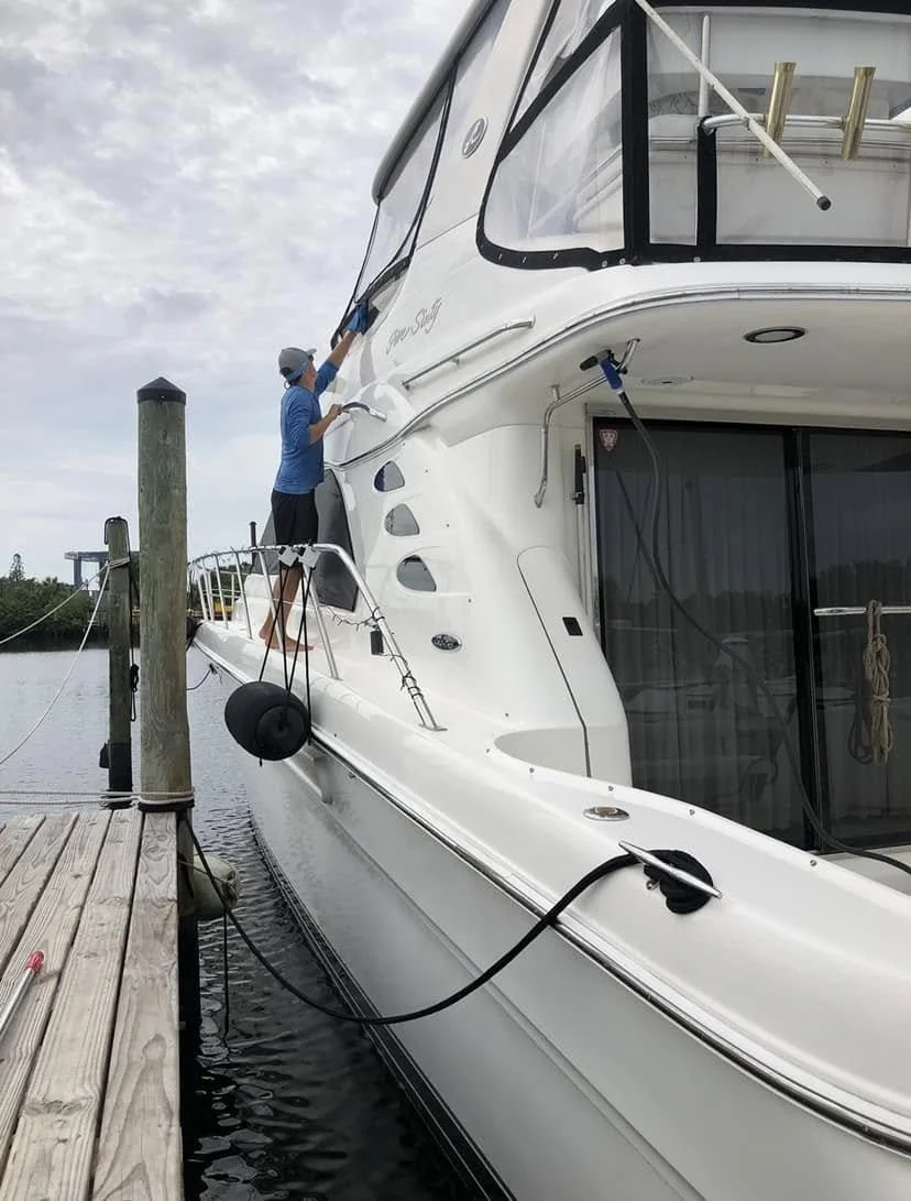 Boat exterior being polished at a marina