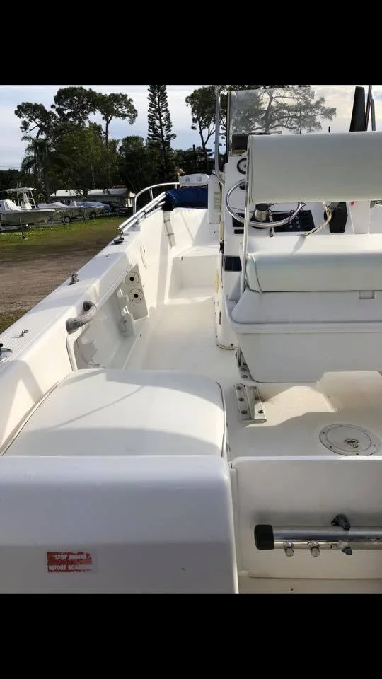Boat detailing technician working on a sailboat