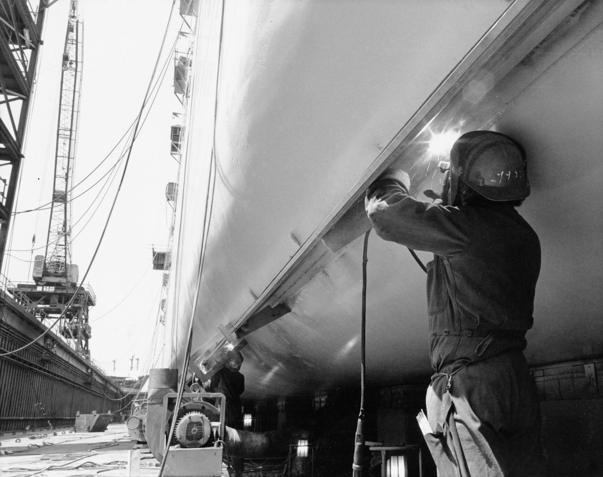 Boat maintenance worker cleaning the underside of a boat
