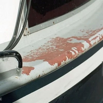 Boat rail with heavy staining and weathered stainless steel hardware
