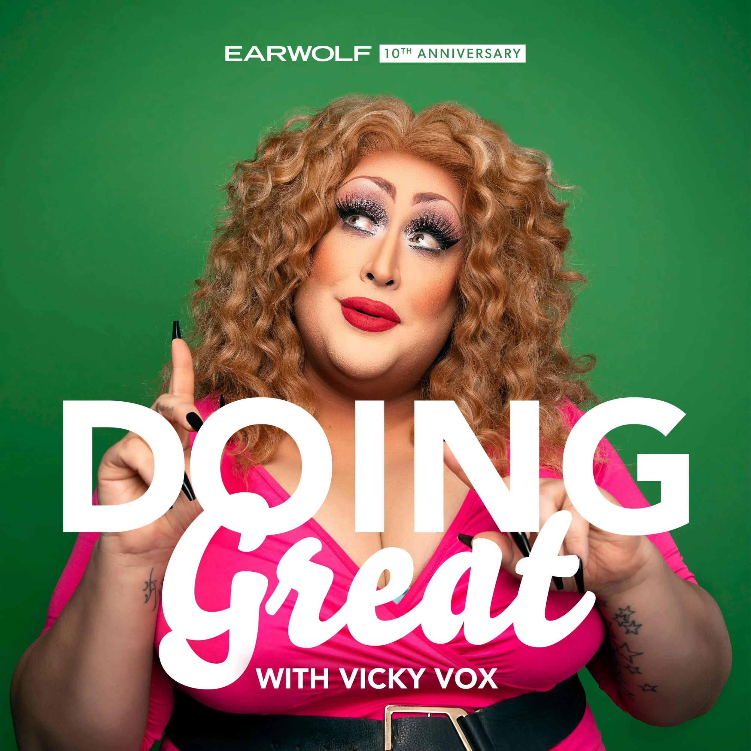 A woman with blonde curly hair and makeup, wearing a pink top, holding makeup brushes, with green background and overlay text 'Doin' Great with Vicky Vox' and '10th Anniversary' at the top.