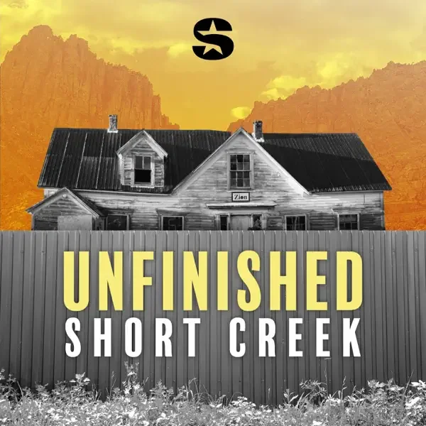 An old, weathered house with a black metal roof behind a tall gray fence, set against a dramatic orange sunset sky with mountains in the background. Text on the image reads "UNFINISHED SHORT CREEK" with a small logo above.