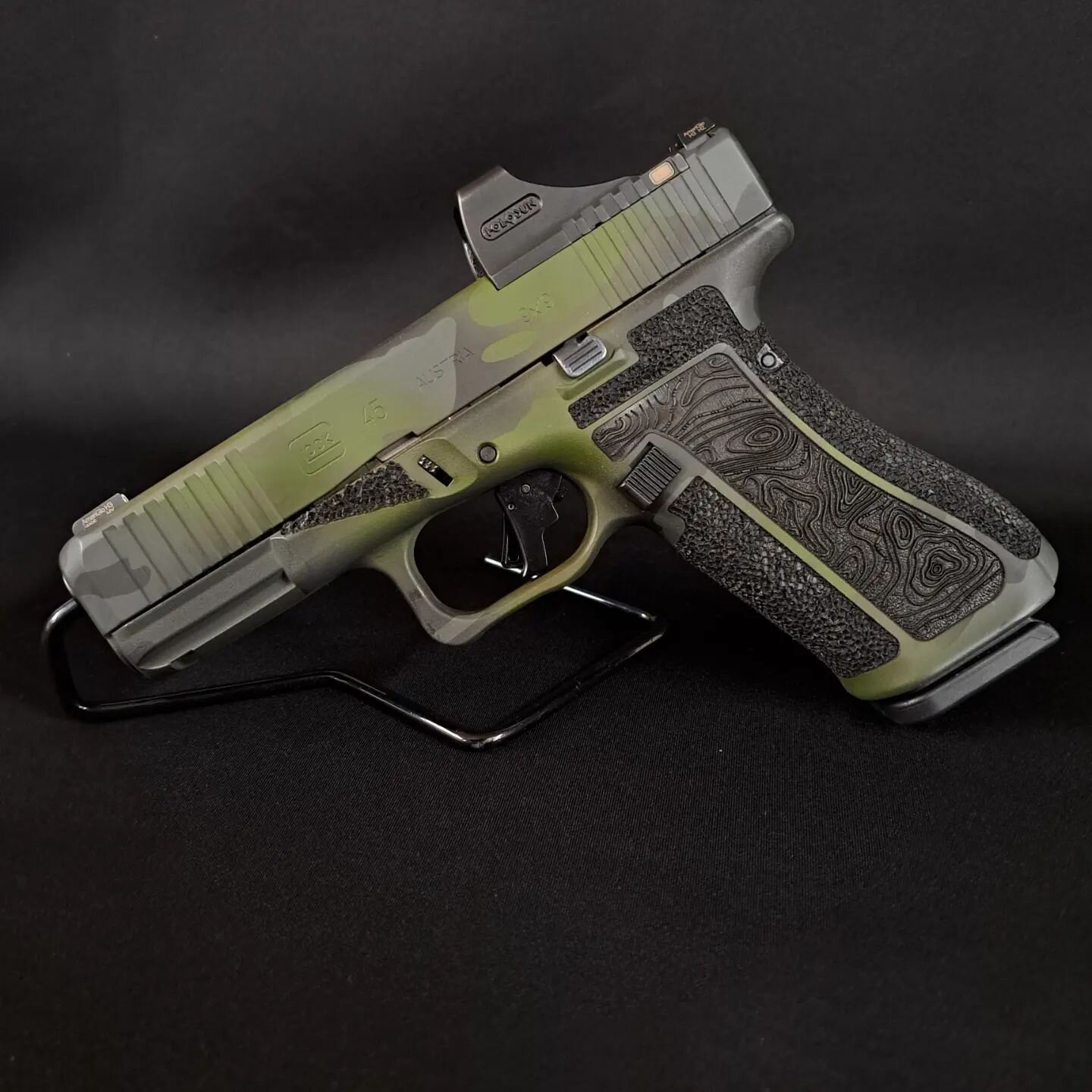 After applying our custom Jungle Camo Cerakote, we combined laser engraving with hand-stippling on this Glock 45 to create something functional and pleasing to the eye. To top it off, the Apex trigger kit paired with some stoning and polishing brough