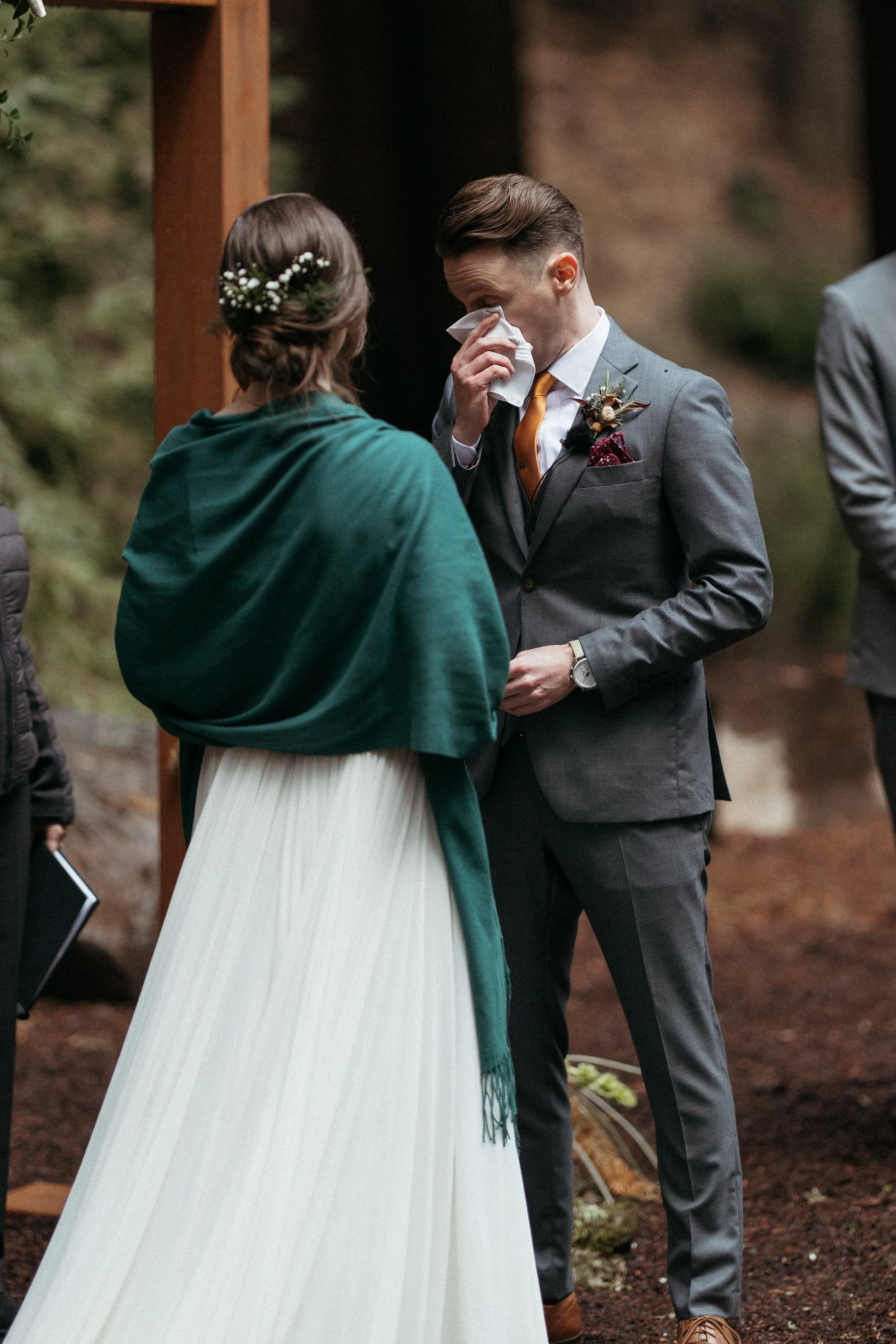 bride and groom exchanging vows beneath redwoods Waterfall Lodge