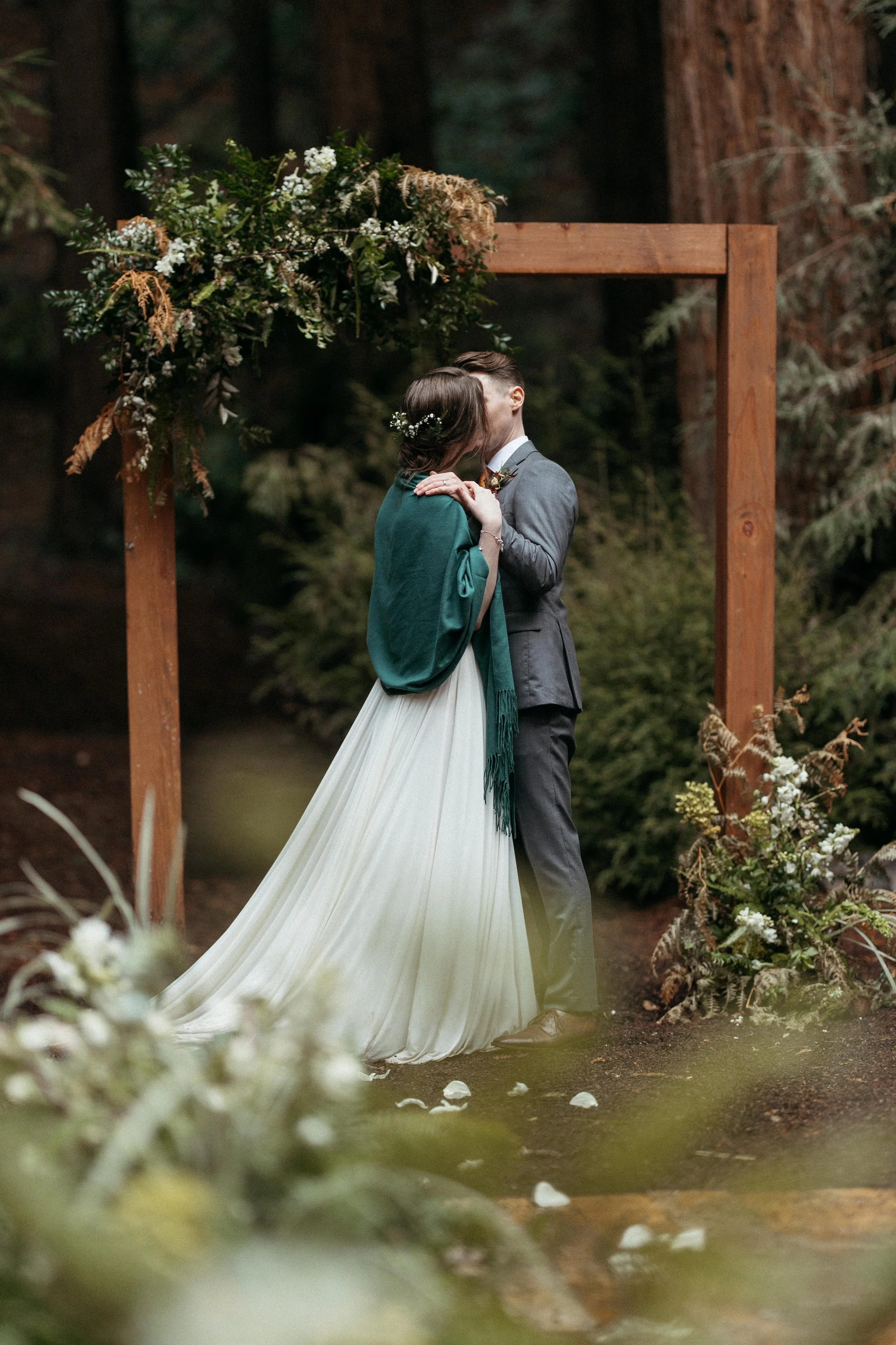 couple embracing after ceremony at Waterfall Lodge redwood grove