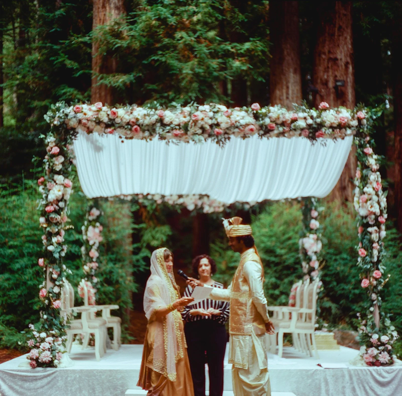 officiant conducting wedding ceremony beneath redwoods at Waterfall Lodge