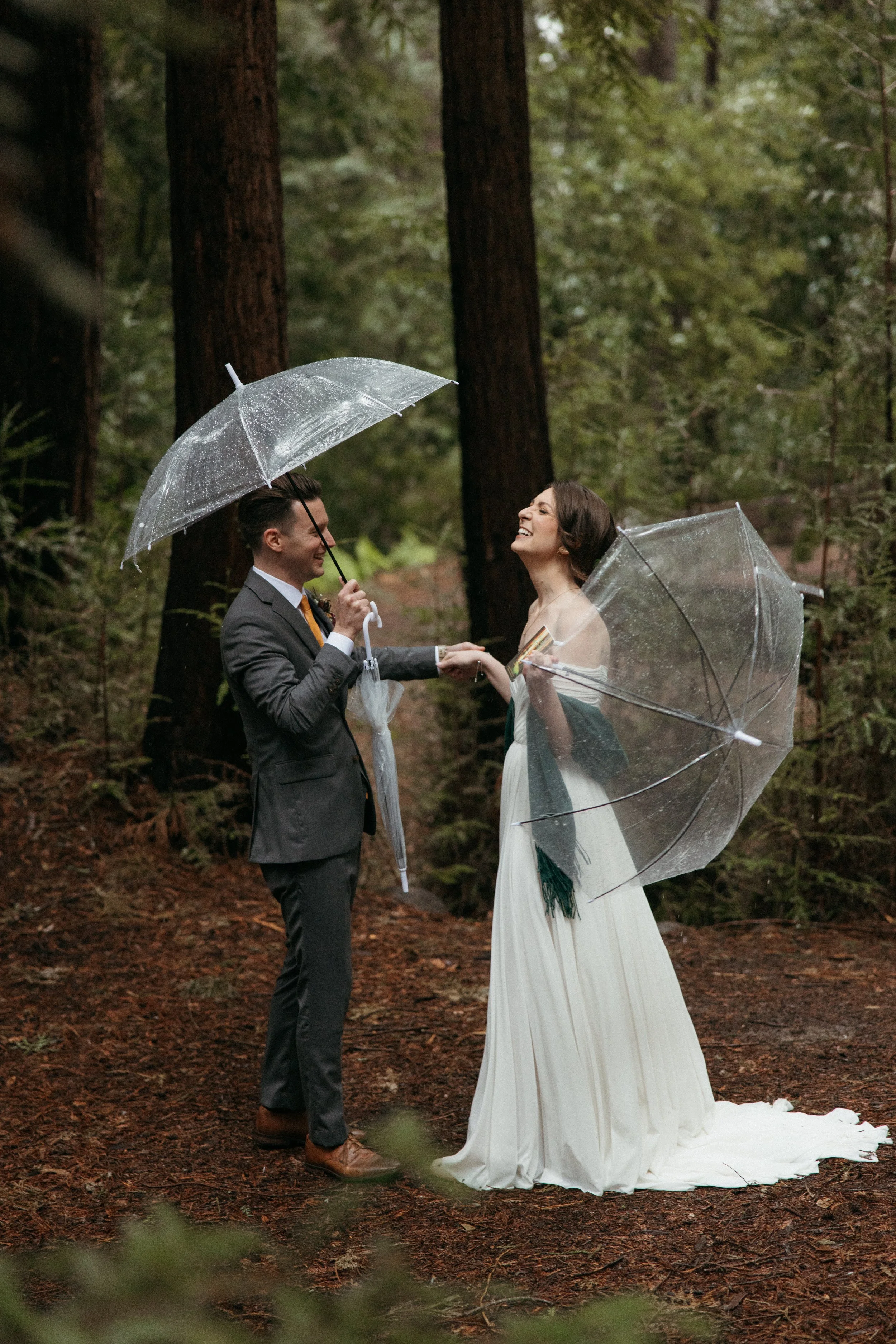 couple walking through redwood grove after ceremony Waterfall Lodge