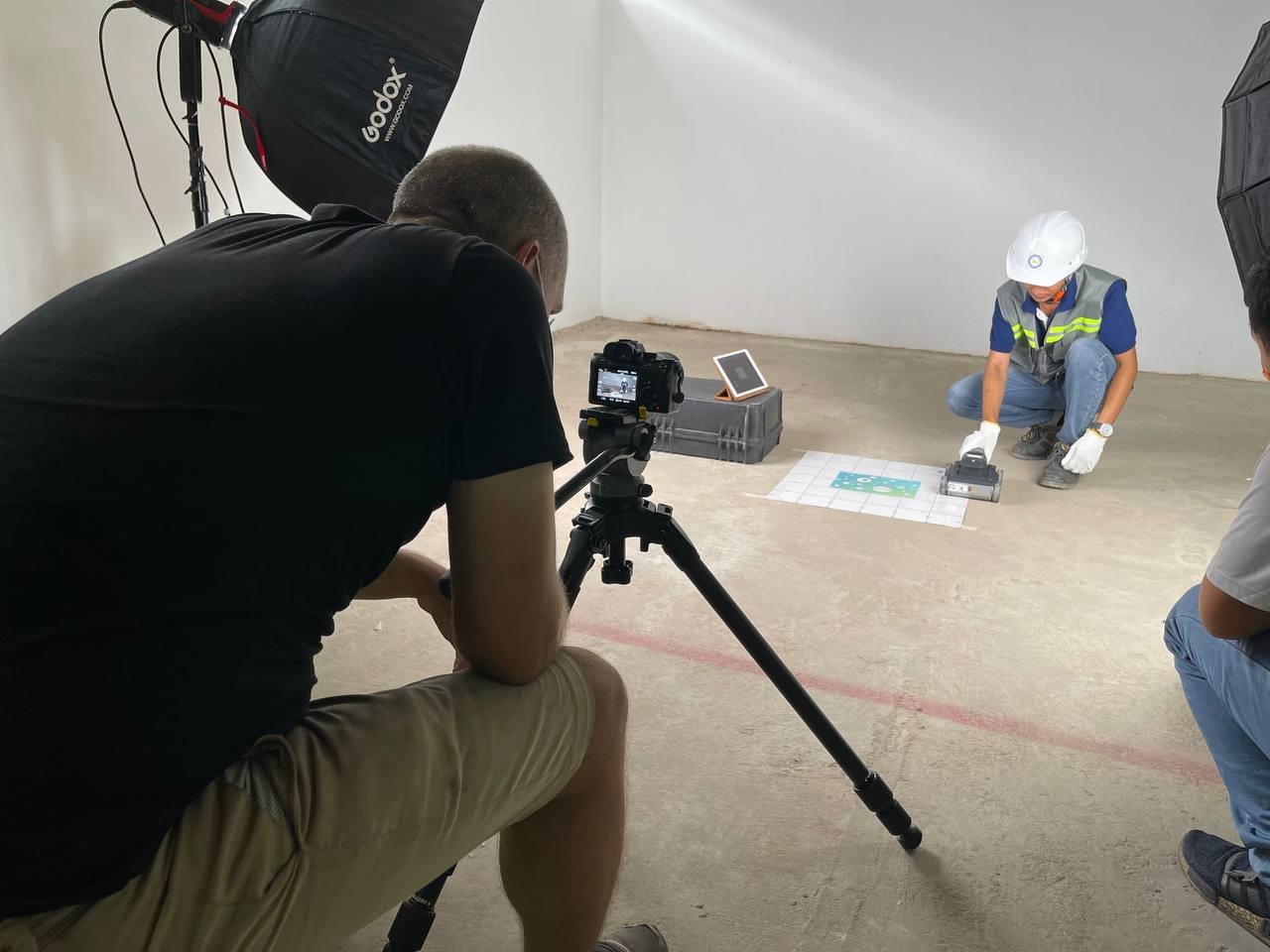 BTS of George working as a lighting camera operator on a concrete test in BECL's laboratory