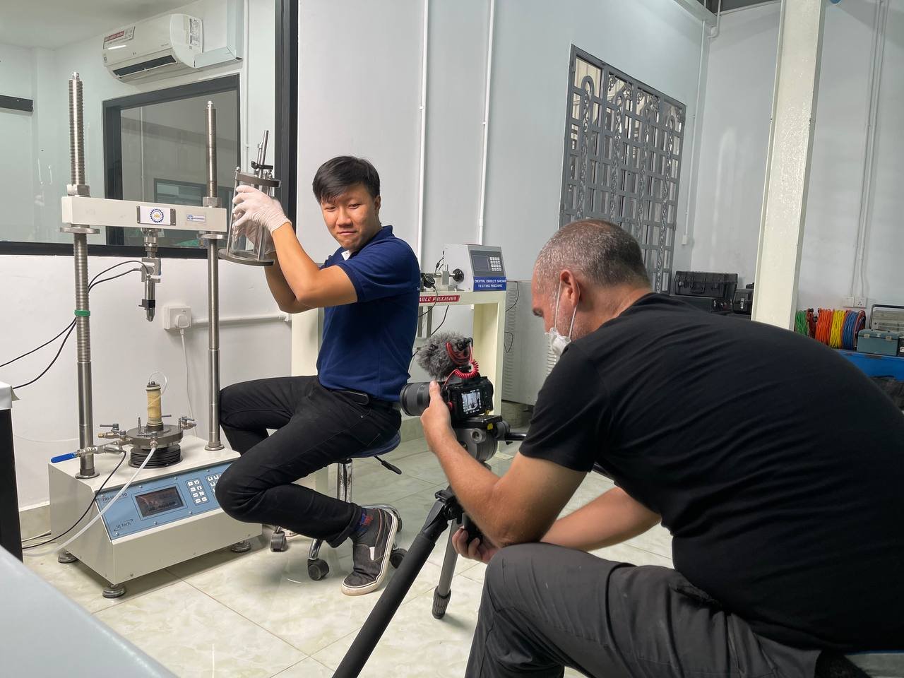 BTS of George working as a videographer filming a test in BECL's lab in Cambodia 