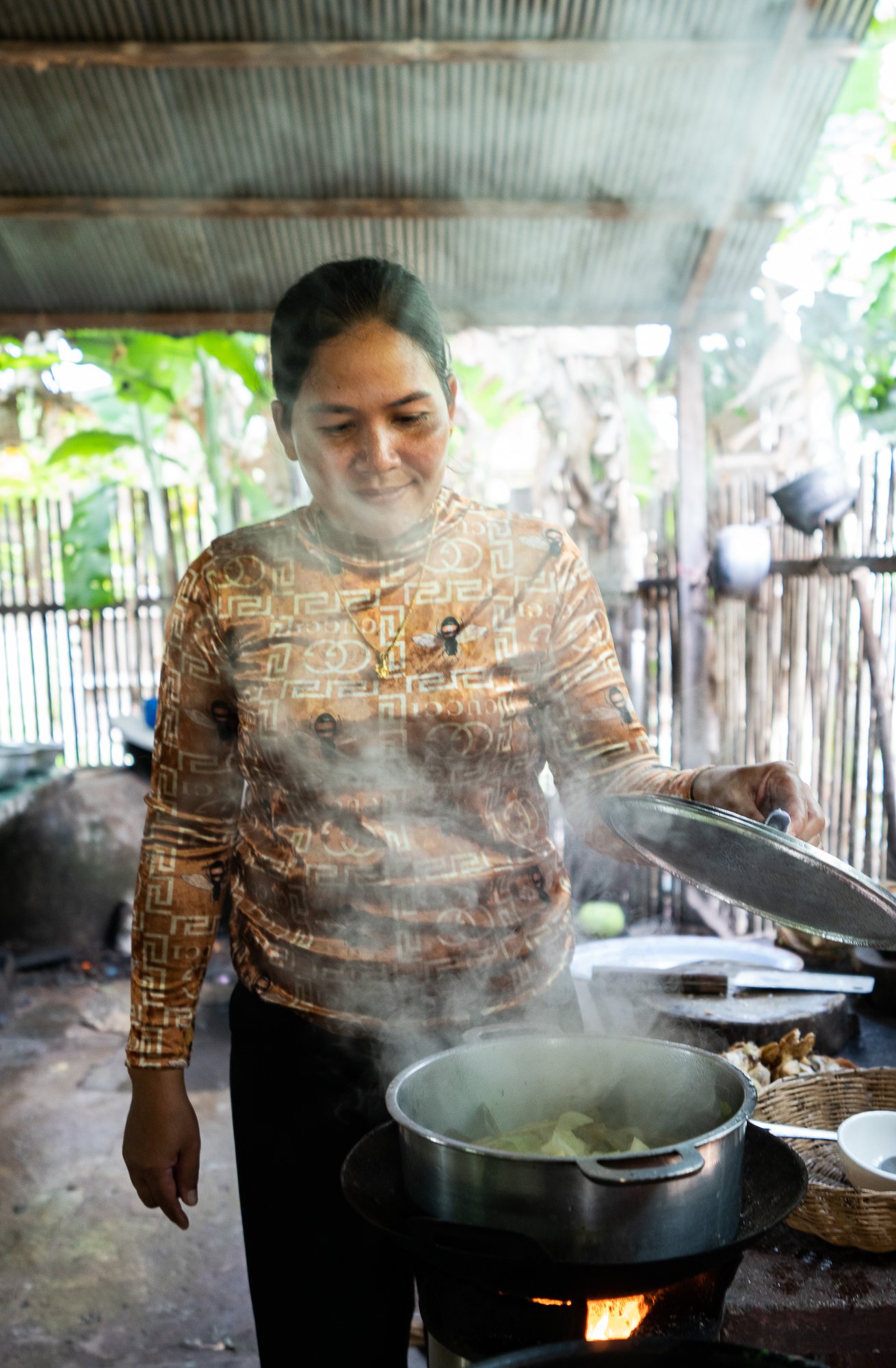 Nil Thach cooks soup using a stove provided by NGO kiva, Siem Reap, Cambodia