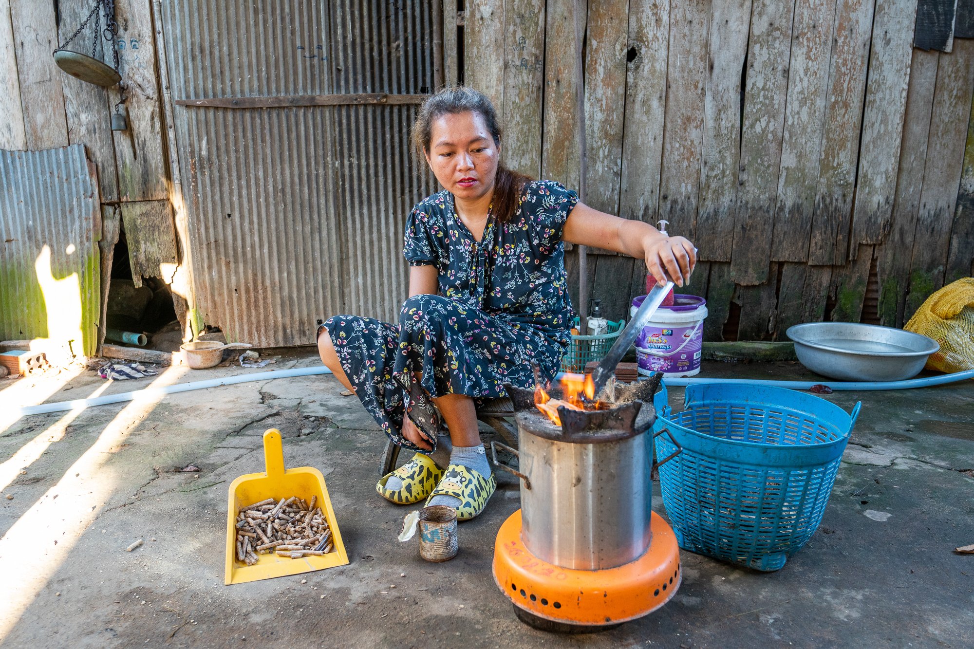 San Sotheary uses her ACE cooking stove to cook soup, Siem Reap, Cambodia