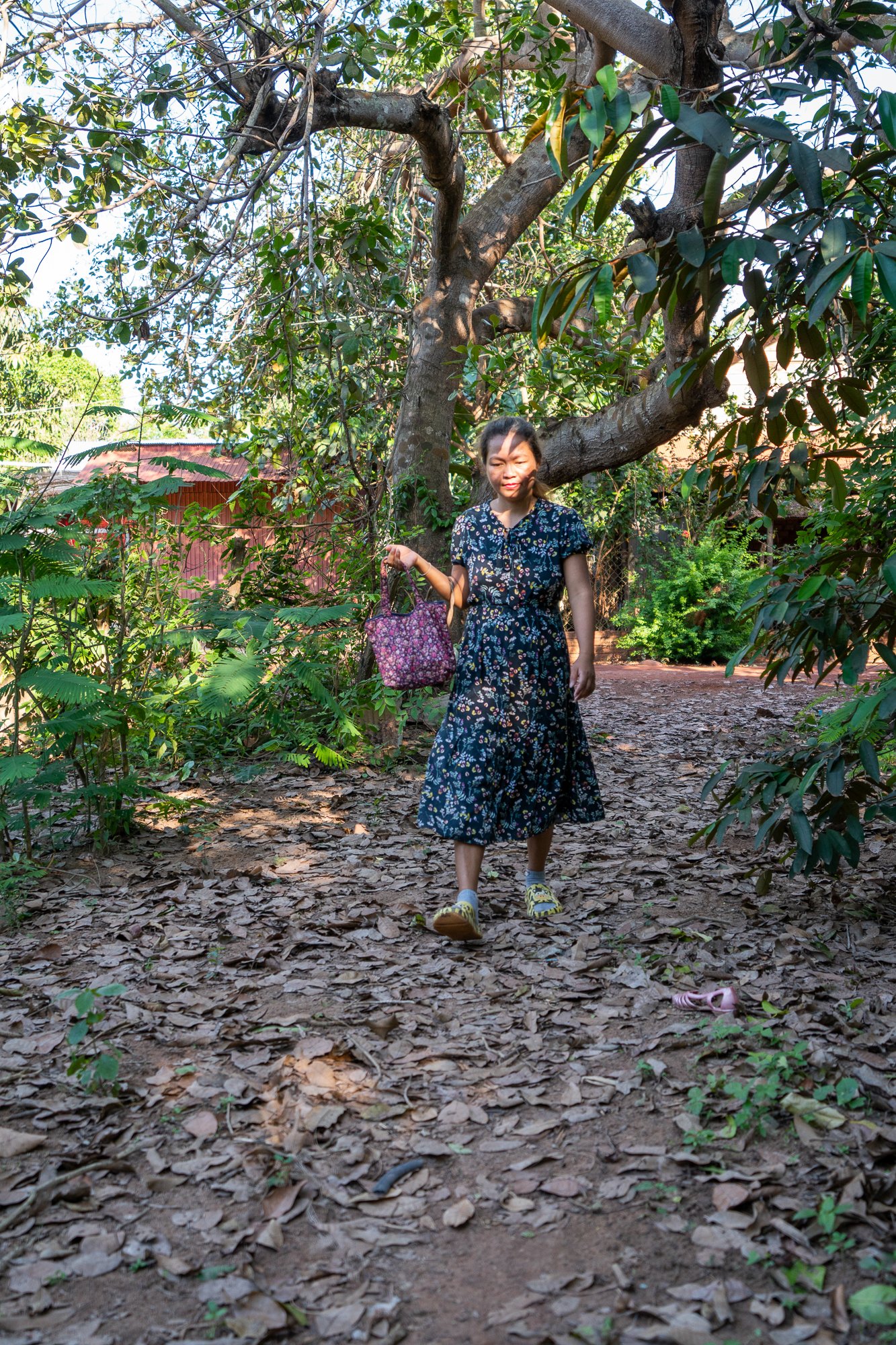 San Sotheary walks home from the market with produce to cook on her ACE stove